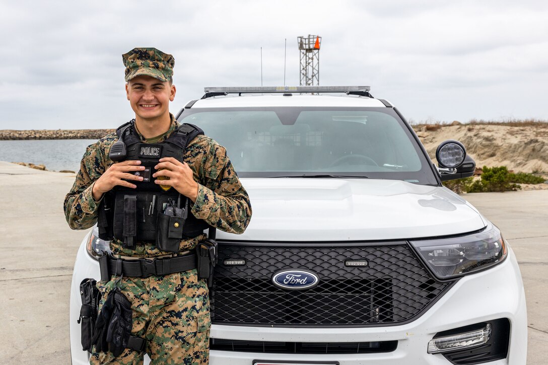 U.S. Marine Corps Lance Cpl. Adam Kish, a military police officer with the Provost Marshal’s Office, Security and Emergency Services Battalion, Marine Corps Base Camp Pendleton stands next to a military police vehicle on MCB Camp Pendleton, California, Sept. 15, 2023. As an MP, Kish ensures the safety and security of MCB Camp Pendleton while also conducting law enforcement operations across the base. A native of Cleveland, Kish has the goal of becoming a firefighter in his hometown. “I do what I can to help people, that's what I came here to do, and if I can bring at least one smile to a person’s face it's a good day,” said Kish. (U.S. Marine Corps photo by Lance Cpl. Mary Jenni)