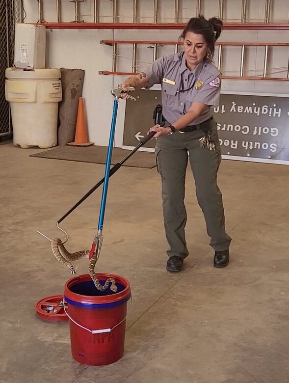 Conchas Park Ranger Nadine Carter demonstrates how to safely relocate a rattlesnake during training, May 5, 2023.