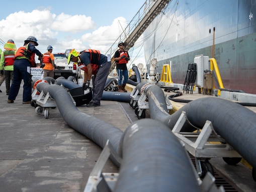 Personnel in support of Joint Task Force-Red Hill (JTF-RH) connect a fuel line to merchant tanker Empire State to enable gravity defueling Oct. 16, 2023, at Joint Base Pearl Harbor-Hickam, Hawaii.