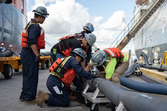 Personnel in support of Joint Task Force-Red Hill (JTF-RH) connect a fuel line to merchant tanker Empire State to enable gravity defueling Oct. 16, 2023, at Joint Base Pearl Harbor-Hickam, Hawaii.