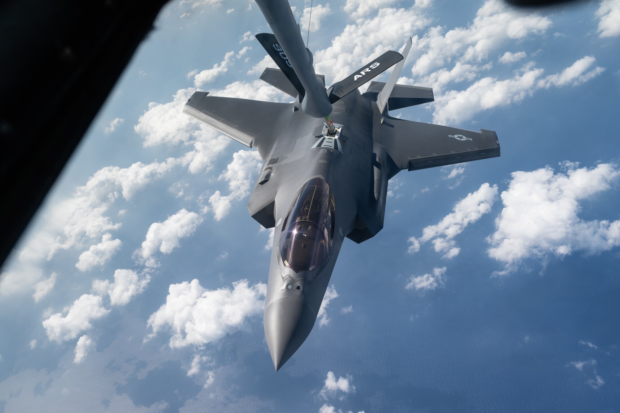 An aircraft conducts aerial refueling.