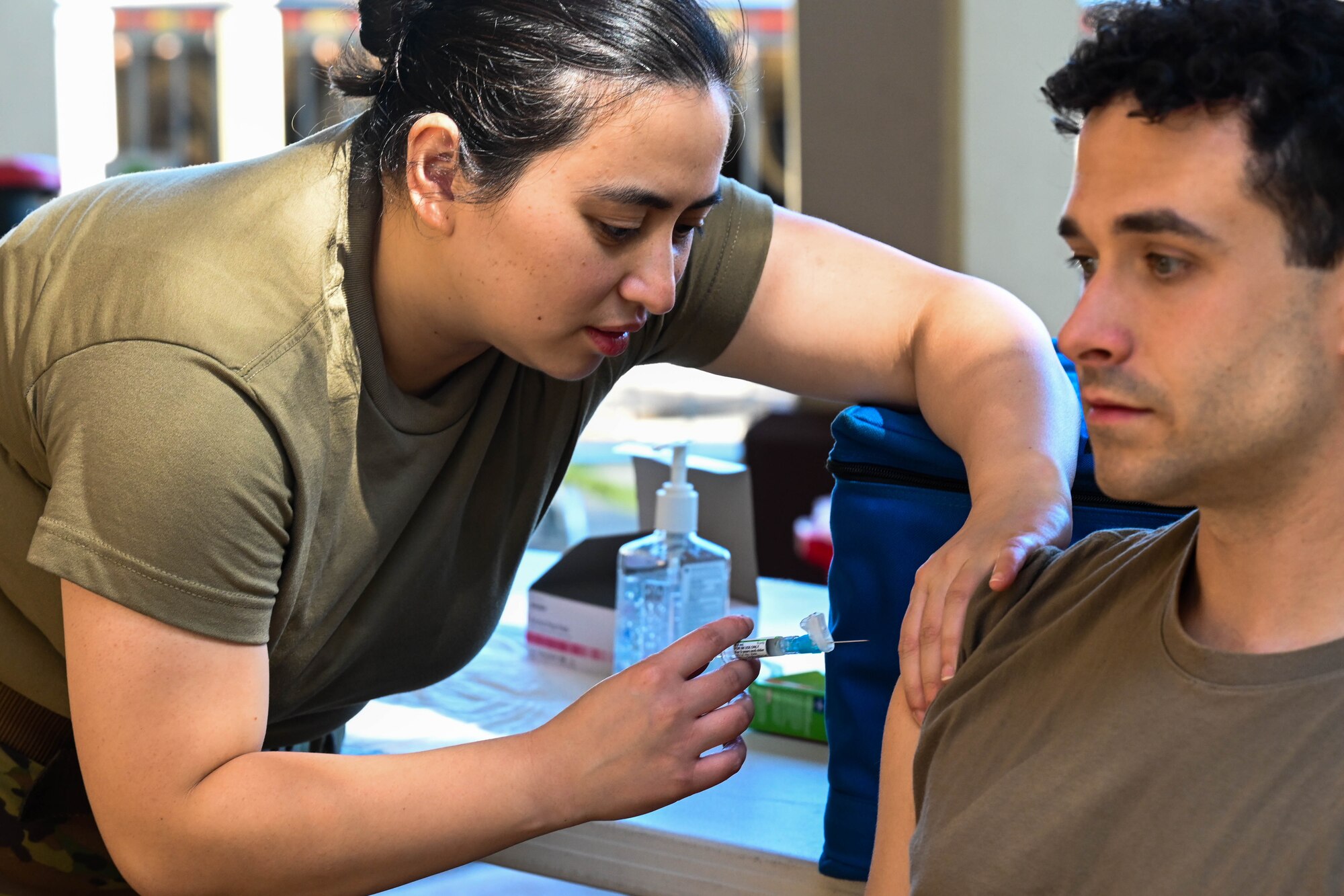 Maj. Lady-Laarni Domingo, 15th Healthcare Operations Squadron critical care action team registered nurse, gives an airman an influenza vaccine during a flu vaccination clinic at Joint Base Pearl Harbor-Hickam, Hawaii, Oct. 18, 2023. The 15th Medical Group ensures the medical readiness of Airmen stationed on the island of Oahu. (U.S. Air Force photo by Senior Airman Makensie Cooper)