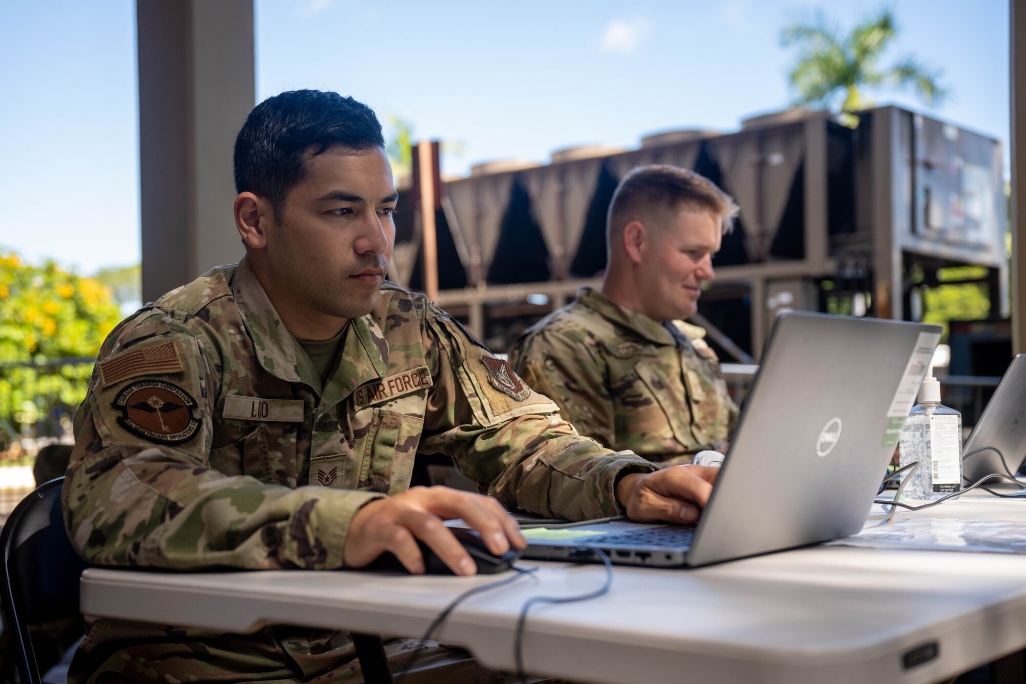 Staff Sgt. Caleb Loo and Staff Sgt. James Young, 15th Healthcare Operations Squadron allergy immunology technicians, check-in patients during a flu influenza vaccination clinic at Joint Base Pearl Harbor-Hickam, Hawaii, Oct. 18, 2023.  The 15th Medical Group hosted the vaccination clinic for three weeks vaccinating thousands of Airmen and their dependents. (U.S. Air Force photo by Senior Airman Makensie Cooper)