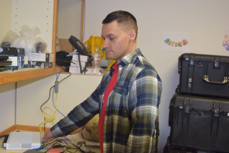 Corps tech support works on modem at Recovery Field Office in Kihei, Hawai'i