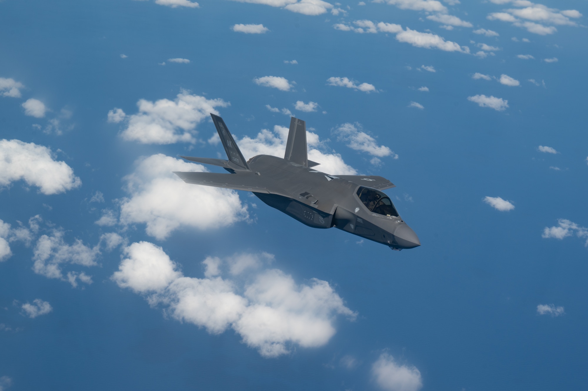 An aircraft flies over the ocean.