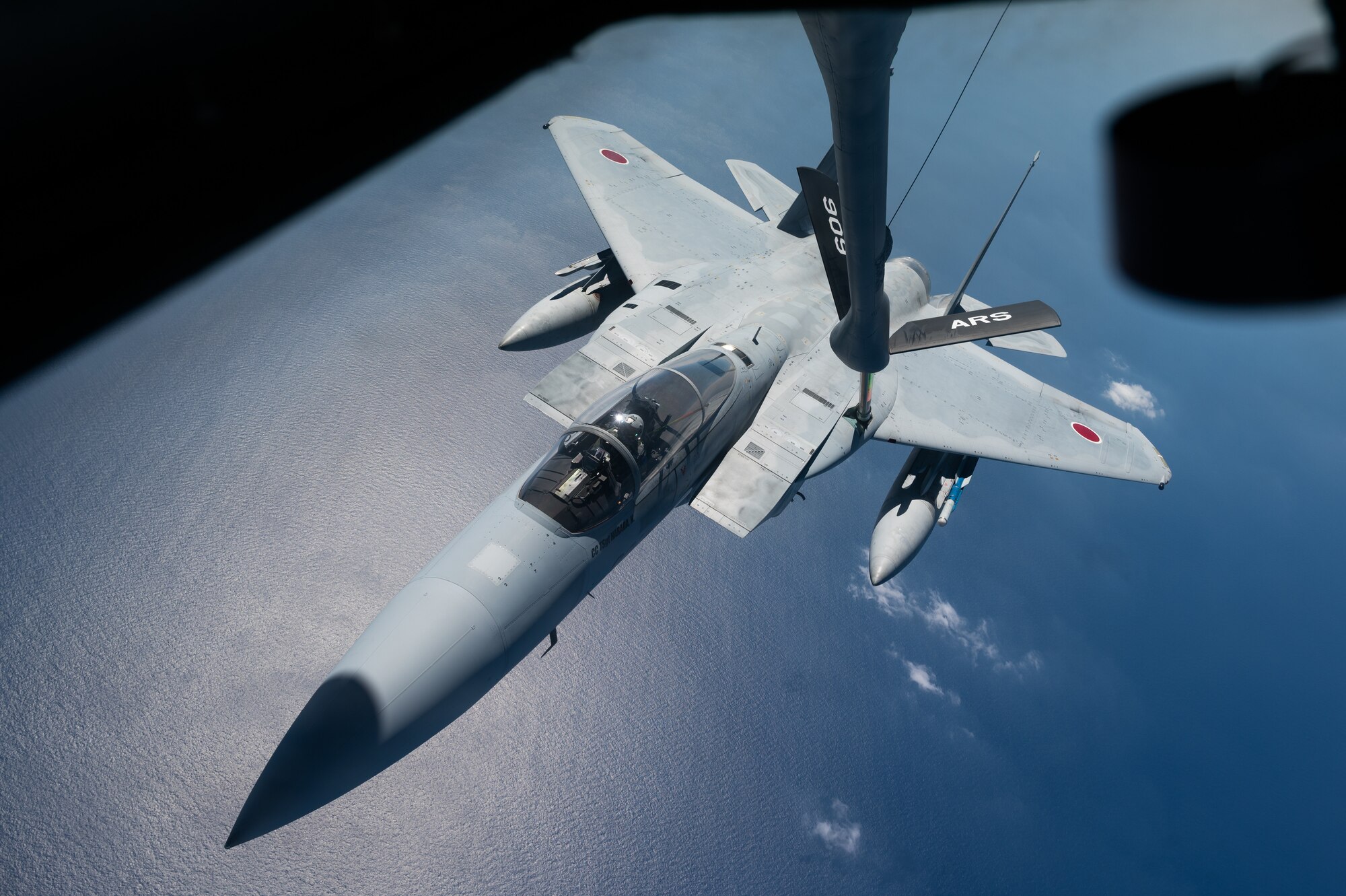 An aircraft conducts aerial refueling.