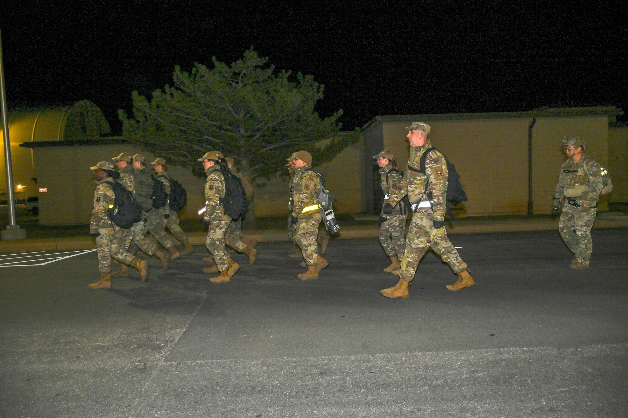 U.S. Air Force Technical Sgt. Ryan Murray, 97th Training Squadron (TRS) lead military training leader (MTL) superintendent, marches his flight to the training area while his evaluator, Master Sgt. Joseph Weidenbach, 97th TRS first sergeant, follows behind during the Talon Challenge at Altus Air Force Base, Oklahoma, Oct. 14, 2023. The title of Master MTL is given to the top 10 percent of training leaders. (U.S. Air Force photo by Airman 1st Class Kari Degraffenreed)