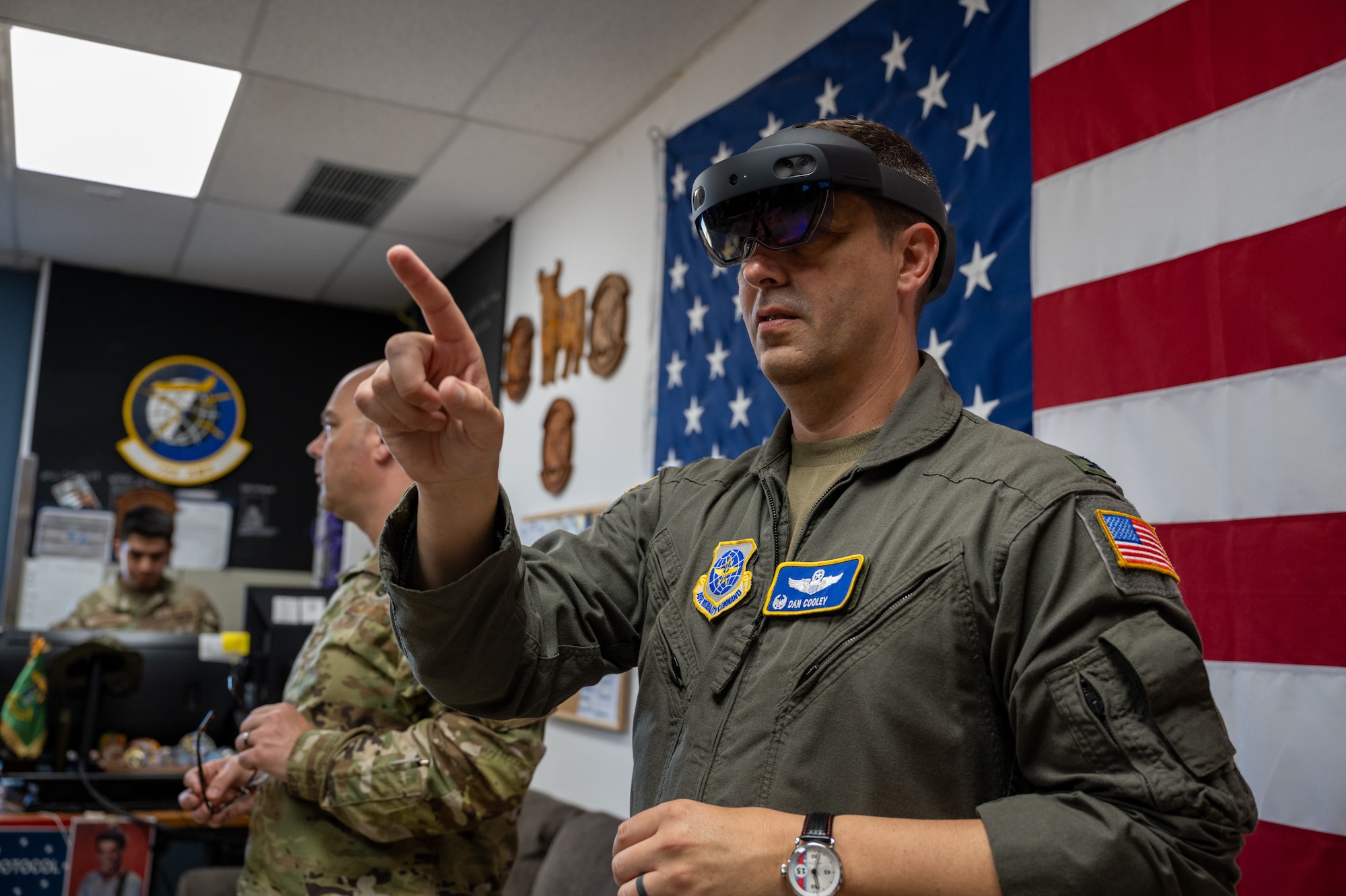 A man in a VR headset reaches his finger out to interact with something on his feed