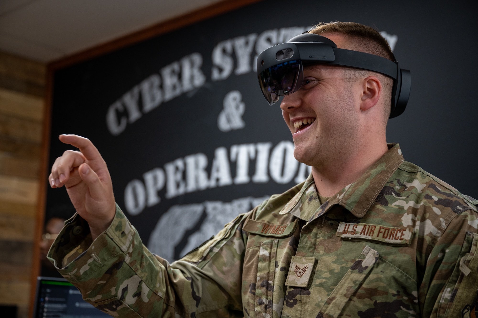 A man in a VR headset reaches out his finger to interact with something on his feed