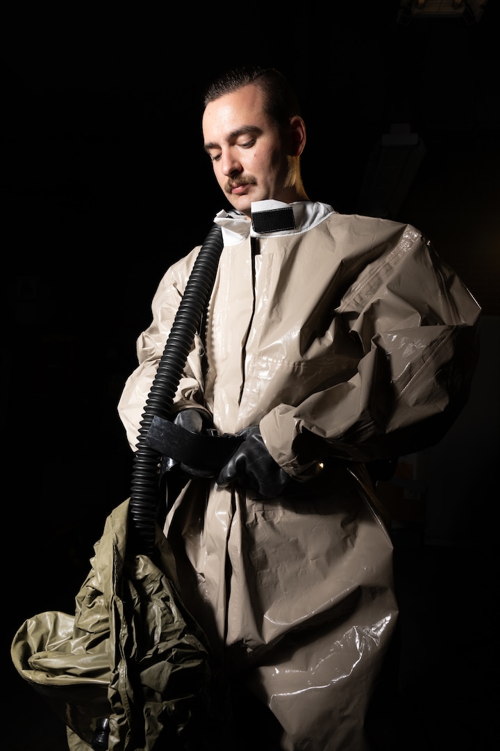 U.S. Air Force Tech. Sgt. Andrew Linton, 436th Operational Medical Readiness Squadron human performance element chief, dons a disposable toxicological agent protective system suit at Dover Air Force Base, Delaware, Oct. 4, 2023. The Warm Zone team is responsible for removing chemical, biological, radiological or nuclear contaminants from patients in need of medical care after an incident or accident. (U.S. Air Force photo by Mauricio Campino)