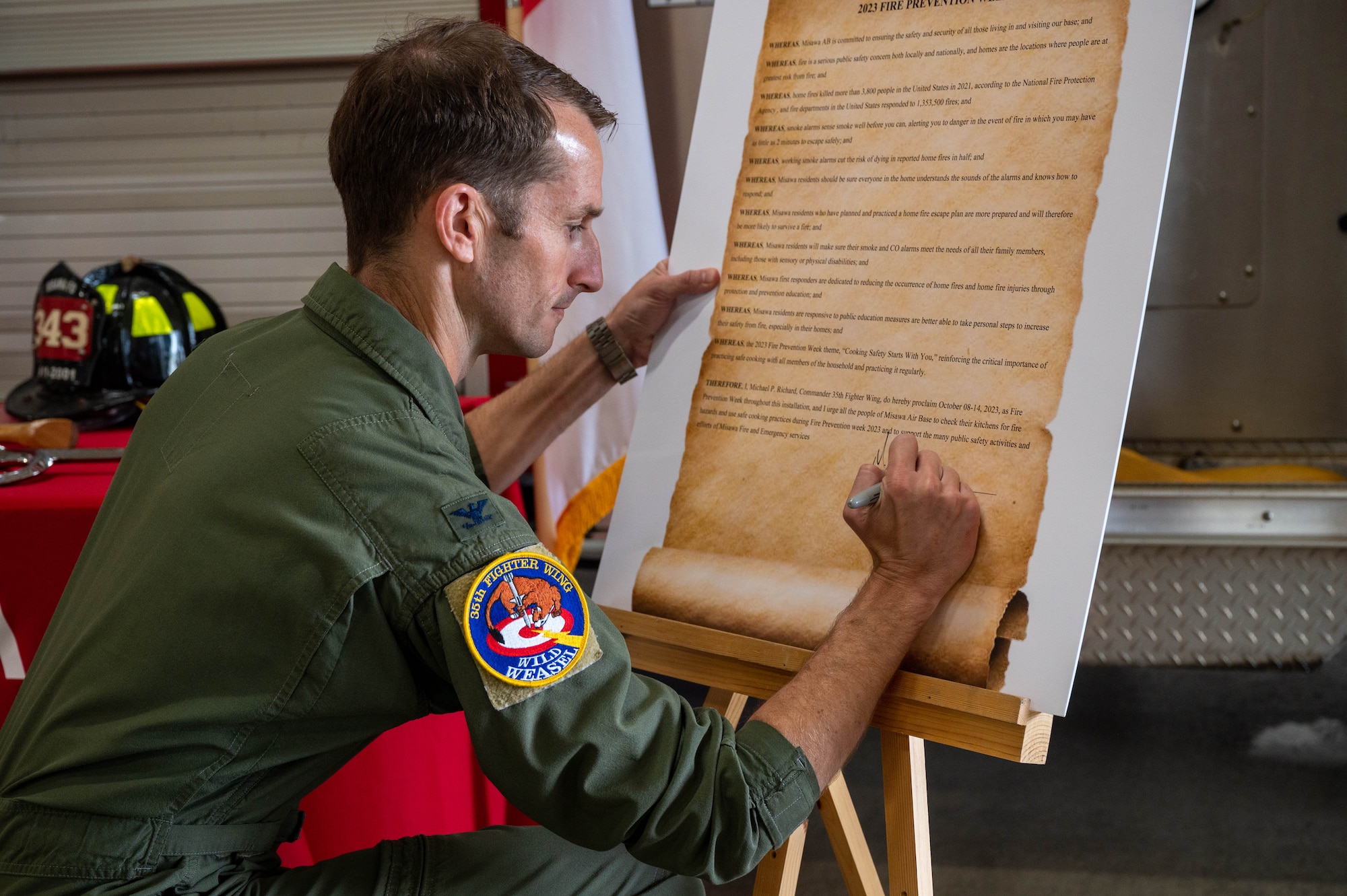 U.S. Air Force Col. Michael Richard, 35th Fighter Wing commander, signs a Fire Prevention Proclamation at Misawa Air Base, Japan, Oct. 5, 2023.