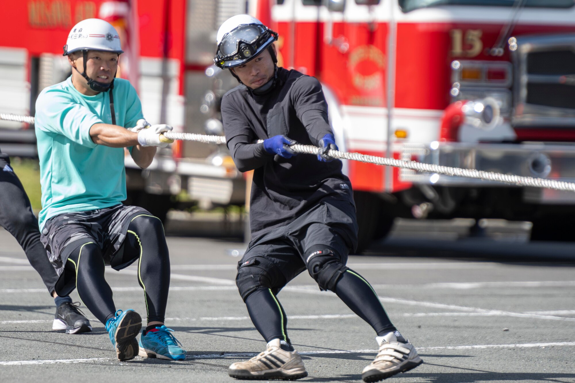 Members of the Misawa City Fire Department pull a fire truck during the annual Fire Prevention Week Fire Muster competition at Misawa Air Base, Japan, Oct. 12, 2023.