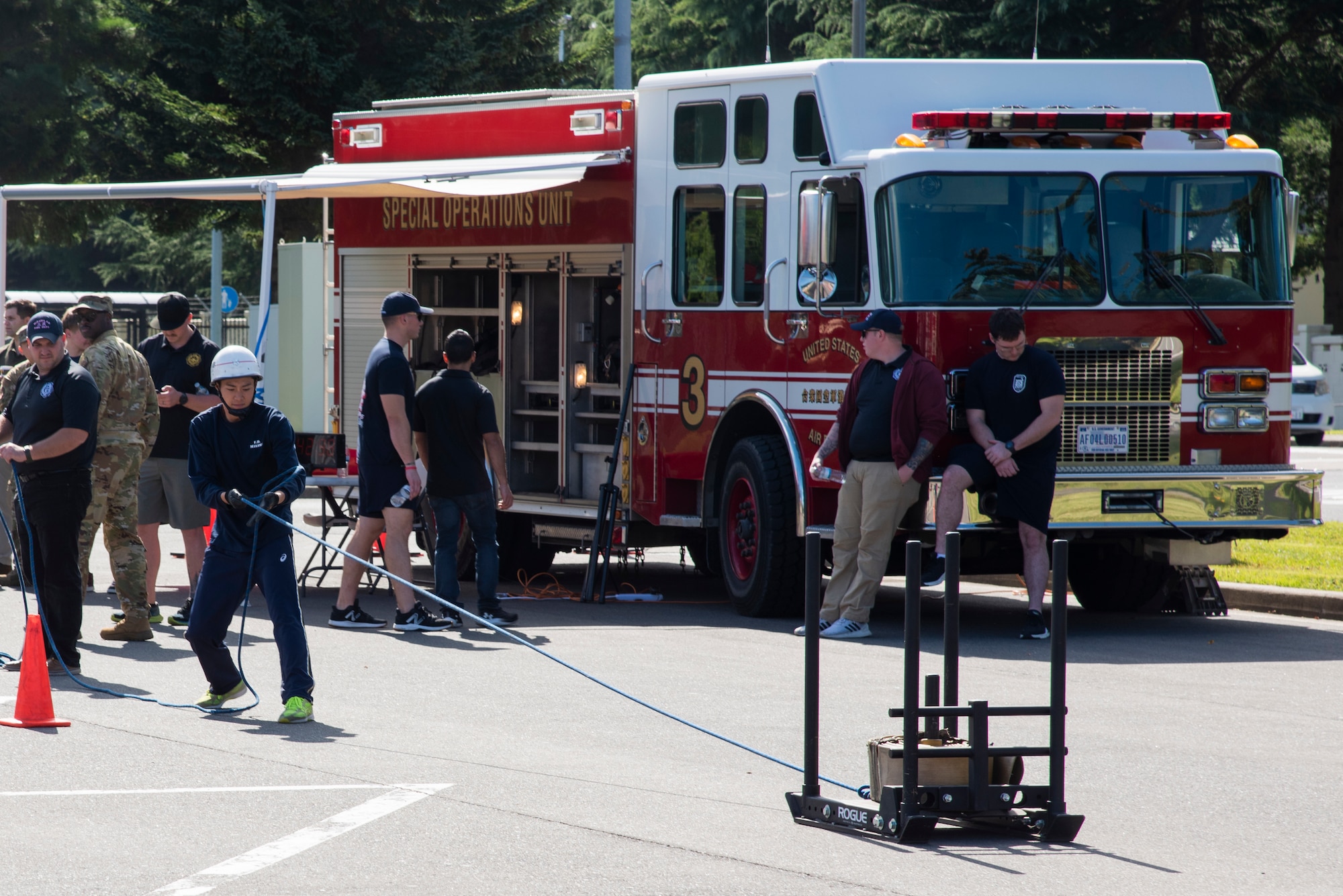 A member of Misawa City Fire Department pulls a weighted sled during the Misawa Air Base Fire Muster at Misawa Air Base, Japan, Oct. 12, 2023.