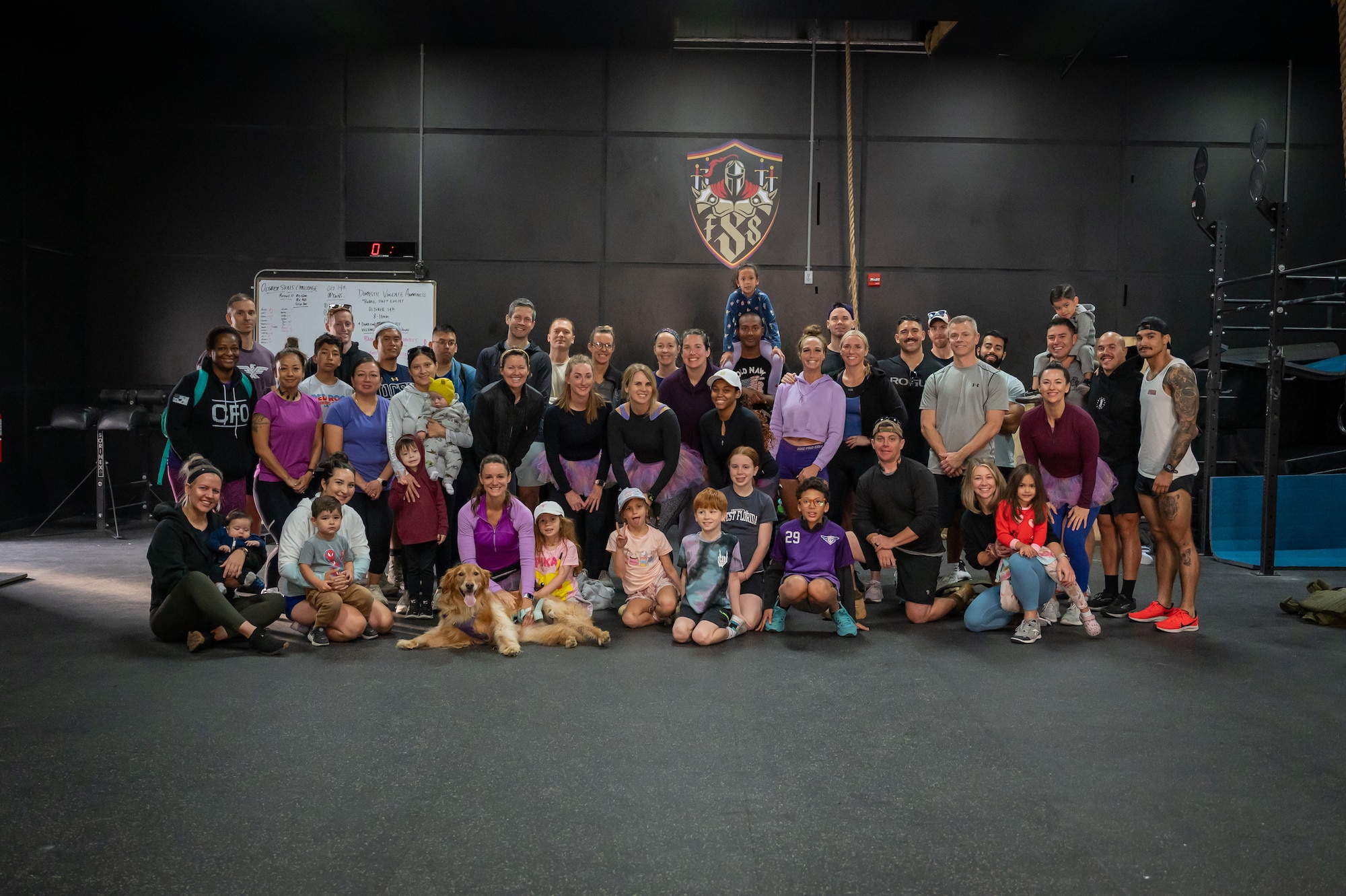 Members of the Osan Air Base community pose for a group photo during a Domestic Violence Awareness Month fitness event at Osan AB, Republic of Korea, Oct. 14, 2023. In recognition of Domestic Violence Awareness Month, members from the Osan community came together to raise awareness and share resources to the base. (U.S. Air Force photo by Staff Sgt. Thomas Sjoberg)