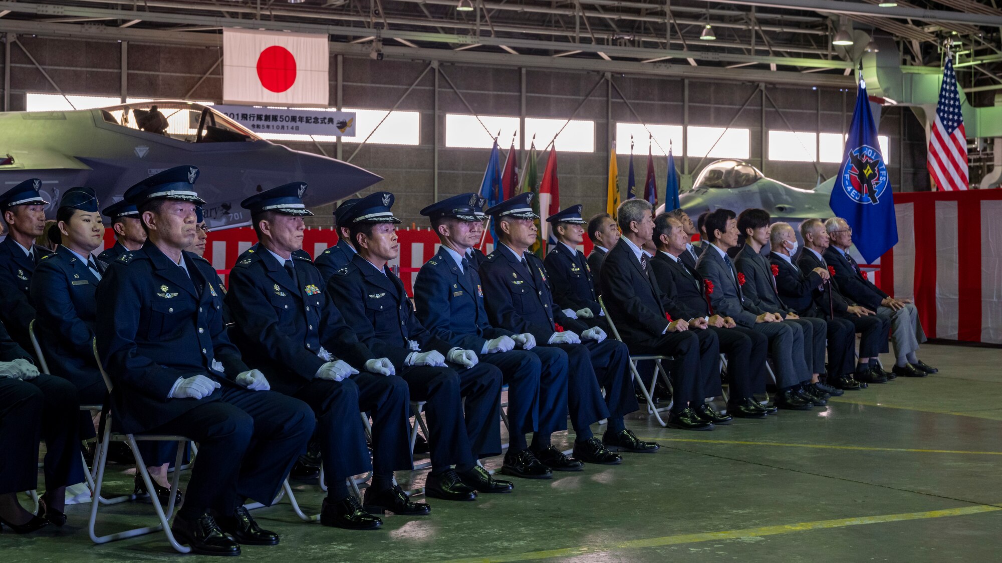 U.S. Air Force and Japan Air Self-Defense Force members watch the 301st Tactical Fighter Squadron’s 50th Anniversary Ceremony at Misawa Air Base, Japan, Oct 14, 2023.