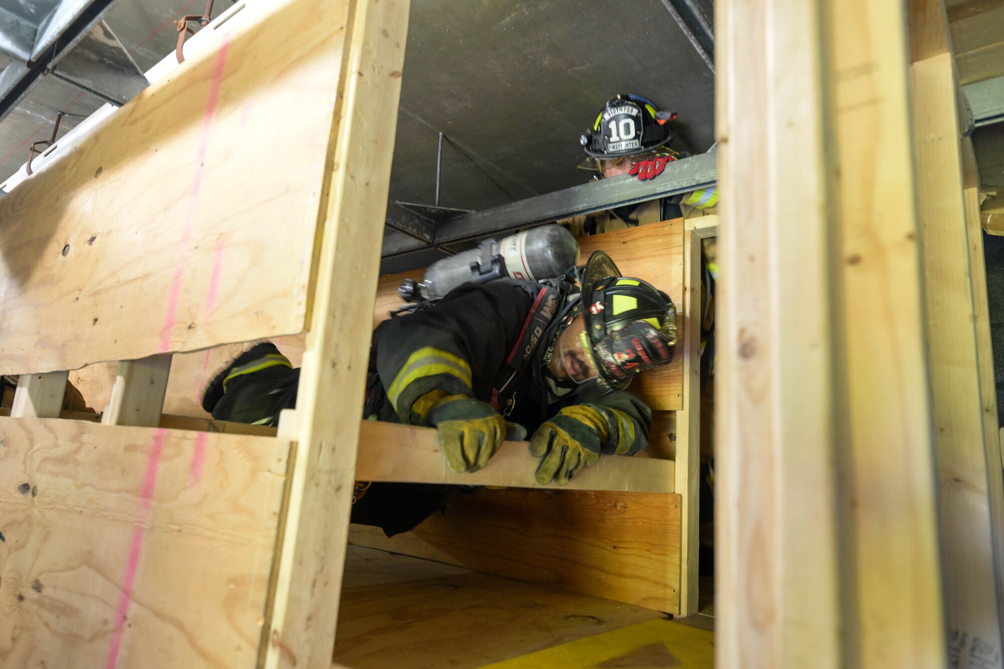 Ron Womack, a firefighter with the Girard Fire Department, crosses a truss crawl in a confined spaces obstacle course at Youngstown Air Reserve Station, Ohio, Oct. 3, 2023.