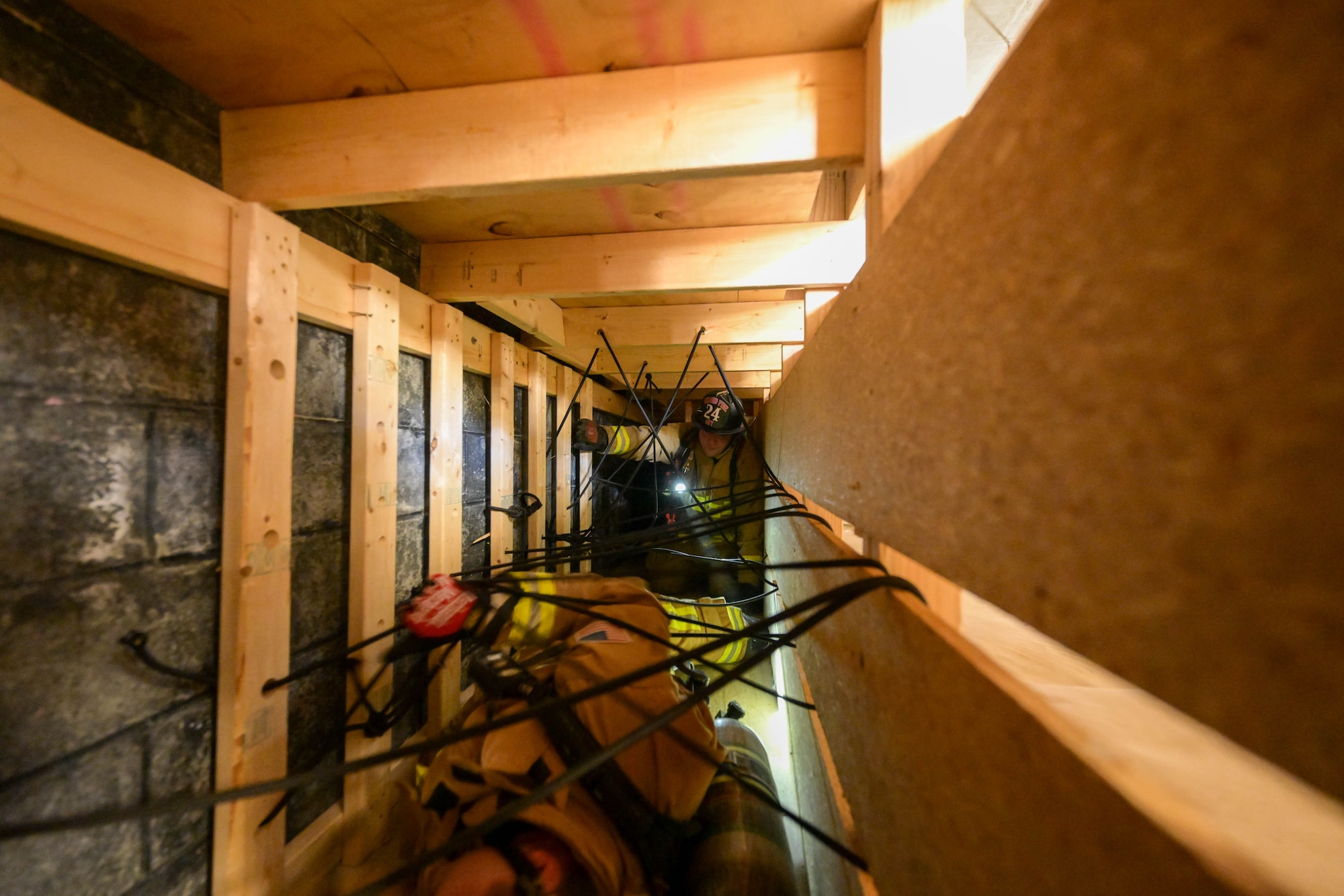 Anthony Mason, a Youngstown Air Reserve Station firefighter, leads Bryan Iceman, a Girard, Ohio firefighter, through a confined space obstacle course at Youngstown Air Reserve Station, Ohio, Oct. 3, 2023.