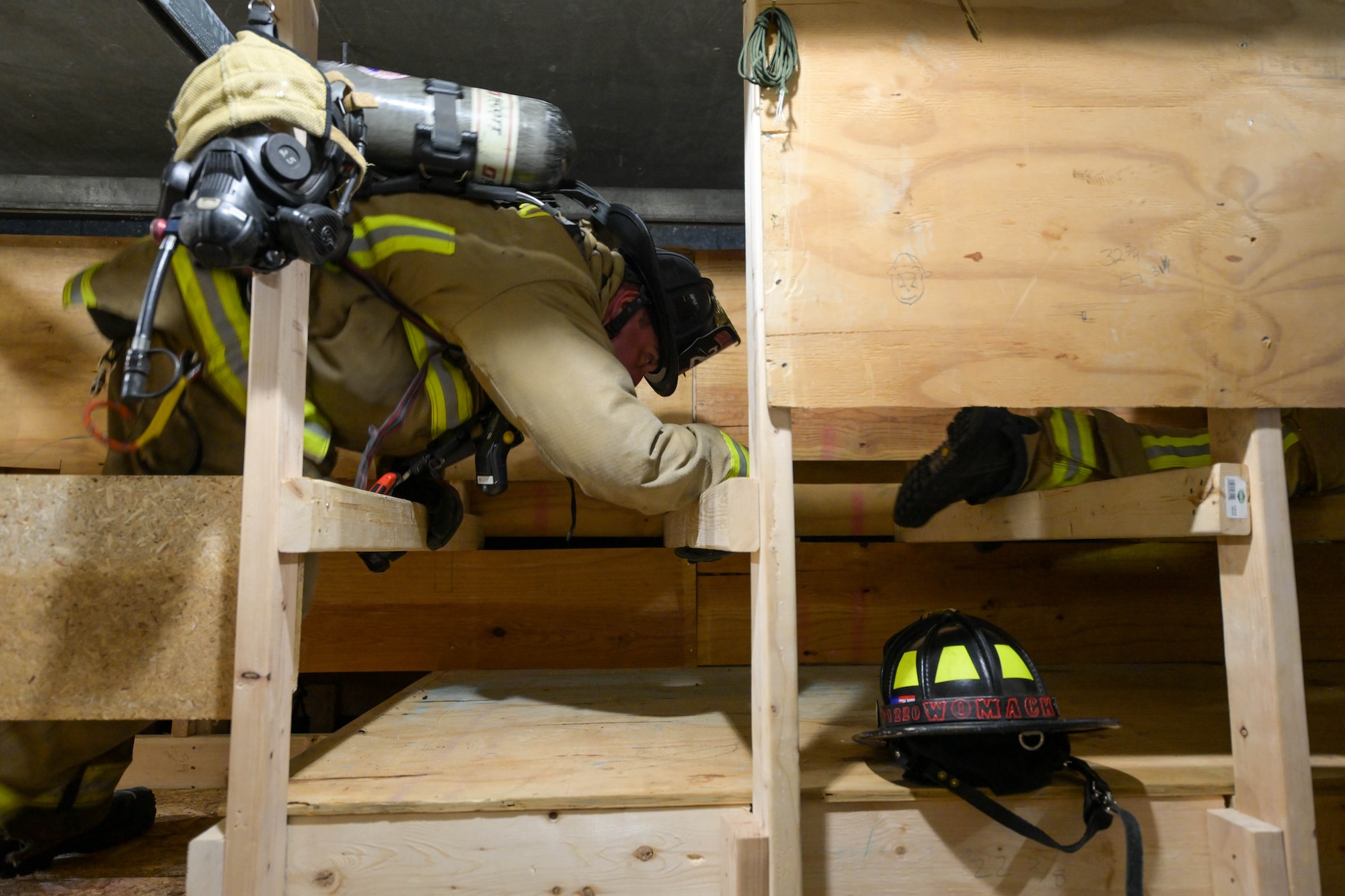 Bryan Iceman, a Girard, Ohio firefighter, crosses a truss crawl in a confined space obstacle course at Youngstown Air Reserve Station, Ohio, Oct. 3, 2023.