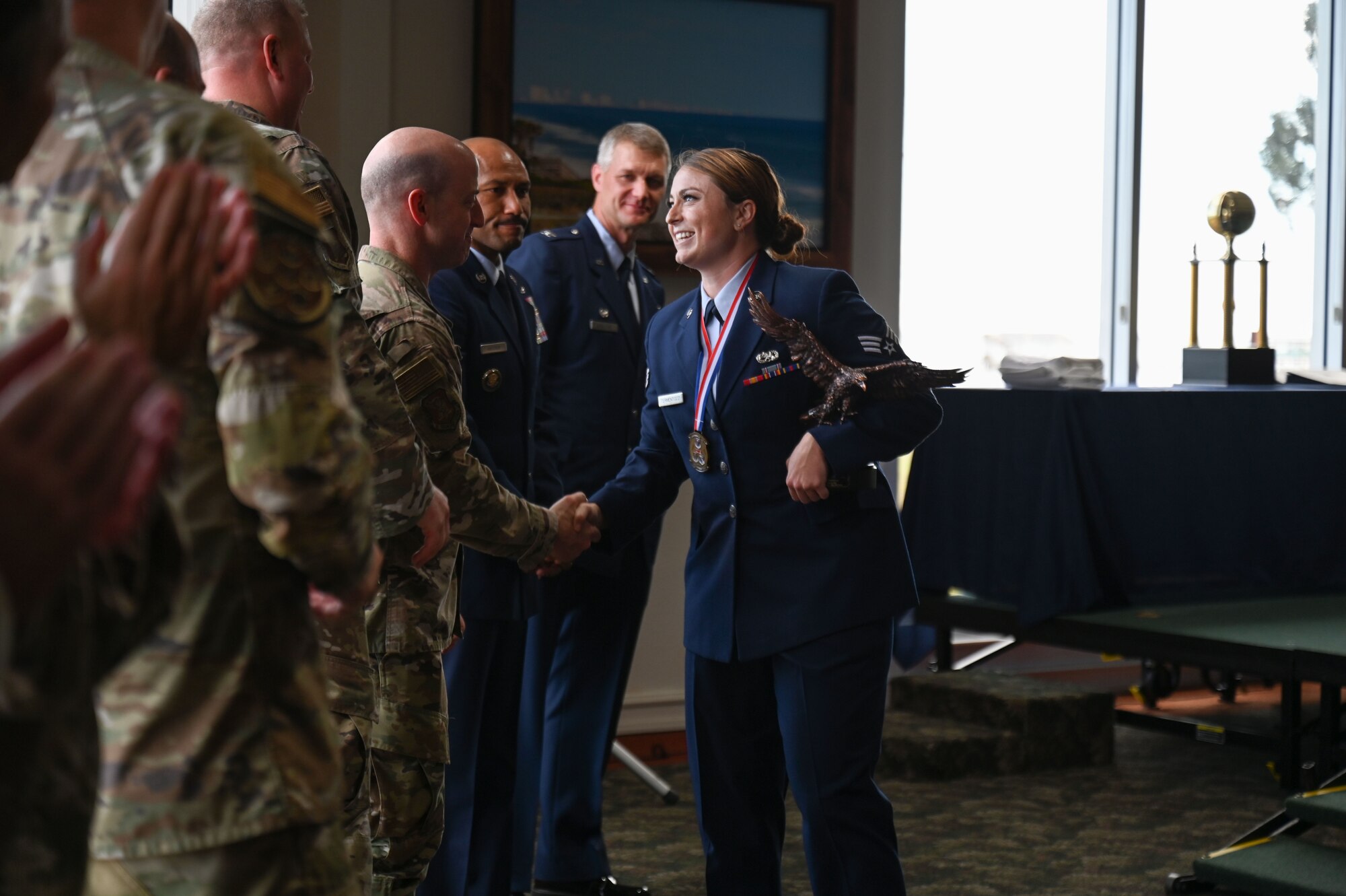 Senior Airman Robbi J. Termentozzi, 350th Spectrum Warfare Wing, WSA programs manager, shakes hands with leadership during Airman Leadership School (ALS) class 23-G graduation at Eglin Air Force Base, Fla., Oct. 19, 2023. Termentozzi won the John L. Levitow Award, which is the highest award for enlisted Professional Military Education in the Air Force. (U.S. Air Force photo by Staff Sgt. Ericka A. Woolever)