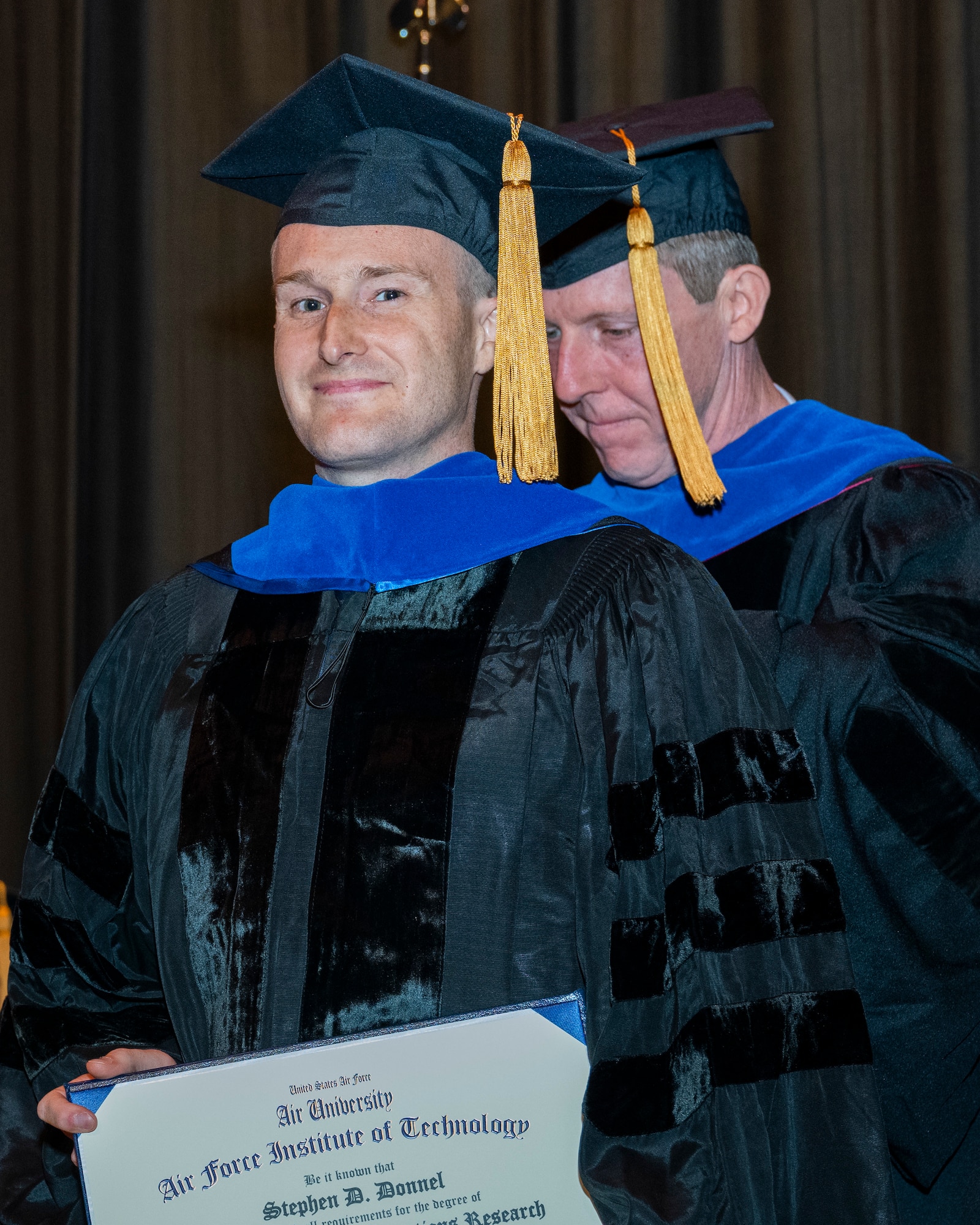 Man wearing graduation regalia
