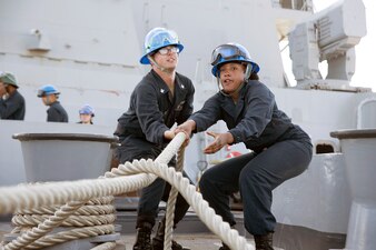 Sailors heave in a mooring line aboard USS San Diego (LPD 22).