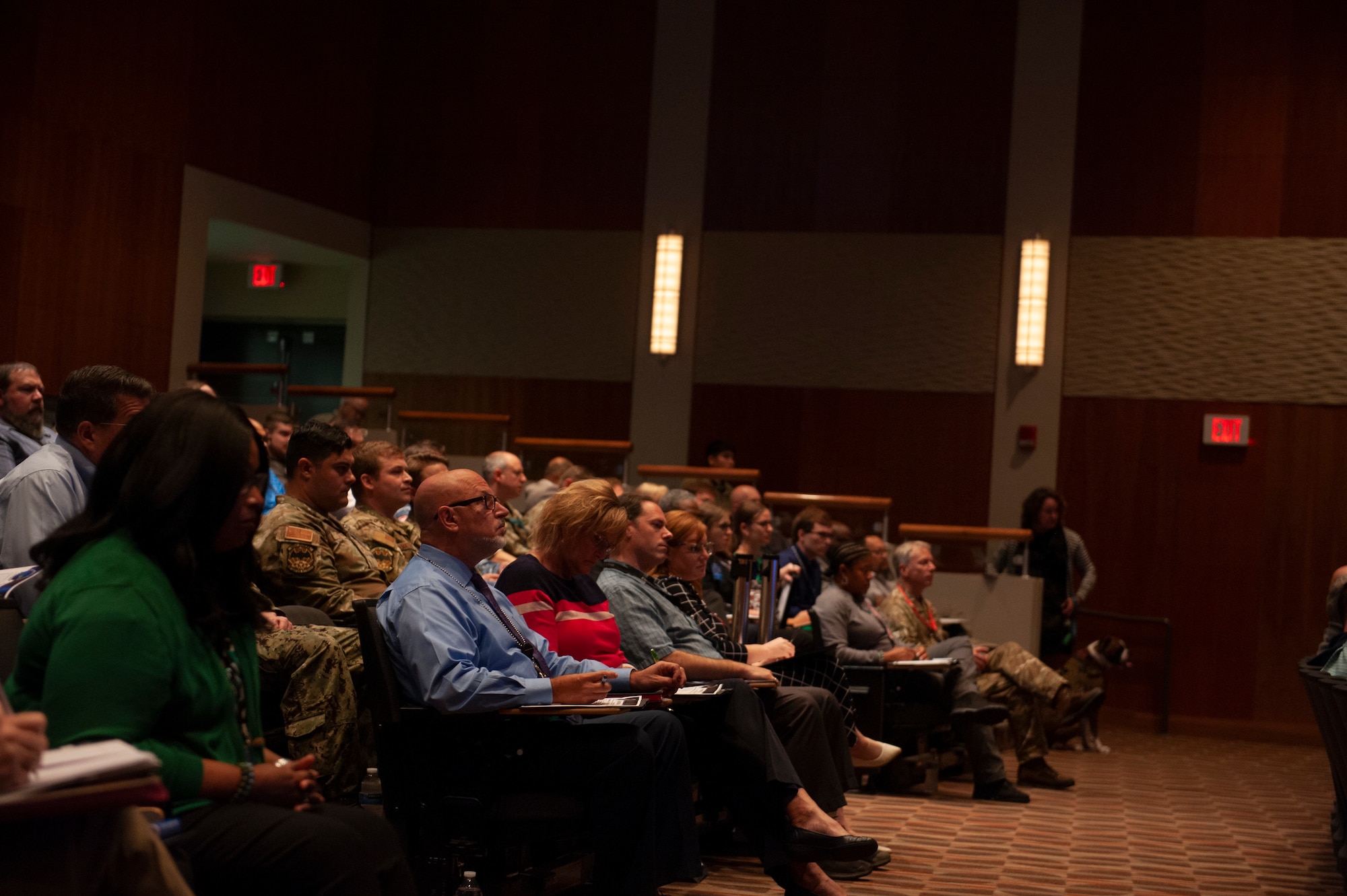 Audience members listen to a briefing presented during the Electromagnetic Spectrum and Cyber Threat Week hosted at the National Air and Space Intelligence Center, Wright-Patterson Air Force Base, Ohio, Sept. 26, 2023. The week-long event offered cross-organizational and international collaboration to address global challenges in EMS and cyber operations.