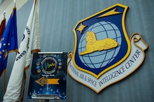 An Electromagnetic Spectrum and Cyber Threat Week poster is displayed near the entrance to the auditorium at the National Air and Space Intelligence Center, Wright-Patterson Air Force Base, Ohio, Sept. 25, 2023. The week-long event was designed to enhance joint force readiness in electromagnetic spectrum operations and cyber capabilities.
