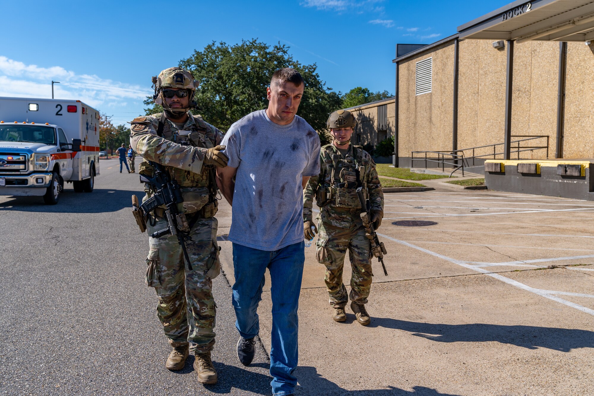 U.S. Air Force Tech. Sgt. Michael Taku, 81st Security Forces Squadron investigator, and Tech. Sgt. Lane Sanchez, 81st SFS unit deployment manager, arrests Airman David Anderson, 338th Training Squadron network systems operator student, during a training exercise at Keesler Air Force Base, Mississippi, Oct. 19, 2023.