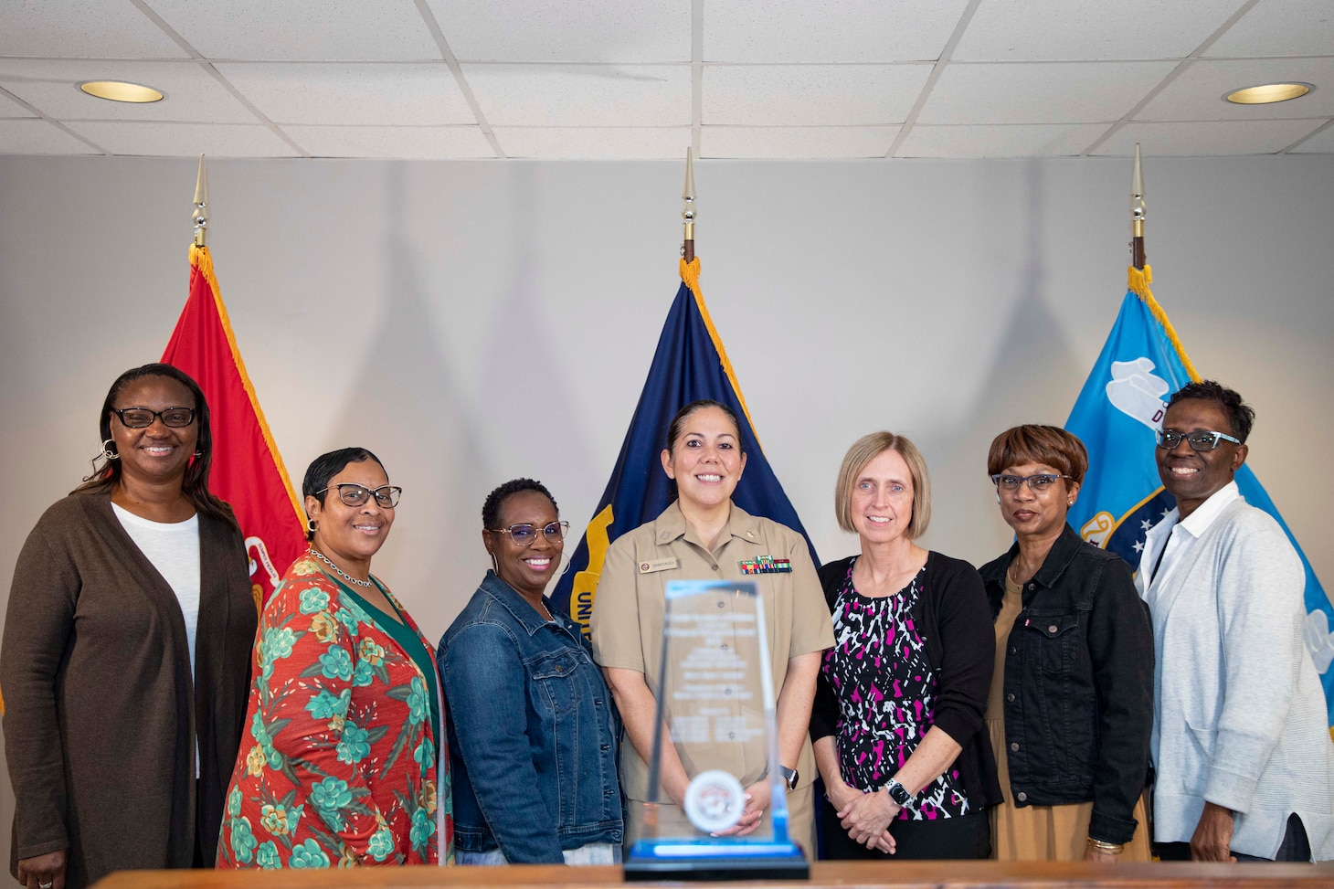 From left, Beverly Hendricks, an accountant, Angela Hinton, a financial management analyst, Mary Leverett-Bazemore, an accountant, Lt. Carla Santiago, an associate comptroller, Carolyn Atkins, a financial management analyst, Michele Jackson, a financial management analyst, and Charlette Worley, a system accountant, assigned to Naval Medical Forces Atlantic pose for a photo with the Under Secretary of Defense (Comptroller) Financial Management Team award for Contributions to End-to-End Business Environment Optimization on board Naval Support Activity (NSA) Hampton Roads - Portsmouth Annex, Sept. 28, 2023.