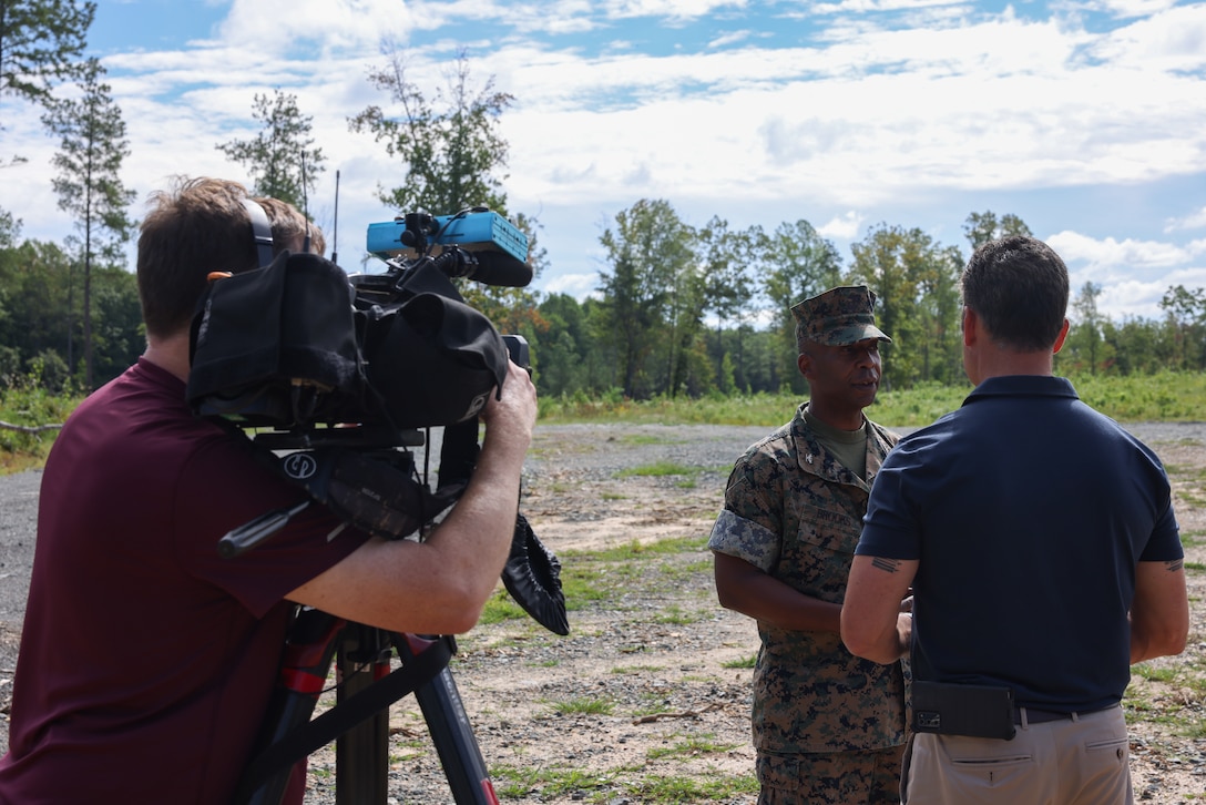 U.S. Marine Corps Col. Michael L. Brooks, base commander, Marine Corps Base Quantico, a native of South Boston, Virginia, gives an interview with visiting journalists at MCBQ, Virginia, Aug. 31, 2023. Journalists from local media outlets toured Quantico's firing ranges to better understand how Marine Corps Base Quantico supports training for its tenant and adjacent commands. Journalists also had the opportunity to speak to Col. Michael L. Brooks, base commander, MCBQ, about the many ways the base partners with the surrounding counties. (U.S. Marine Corps photo by Lance Cpl. David Brandes)