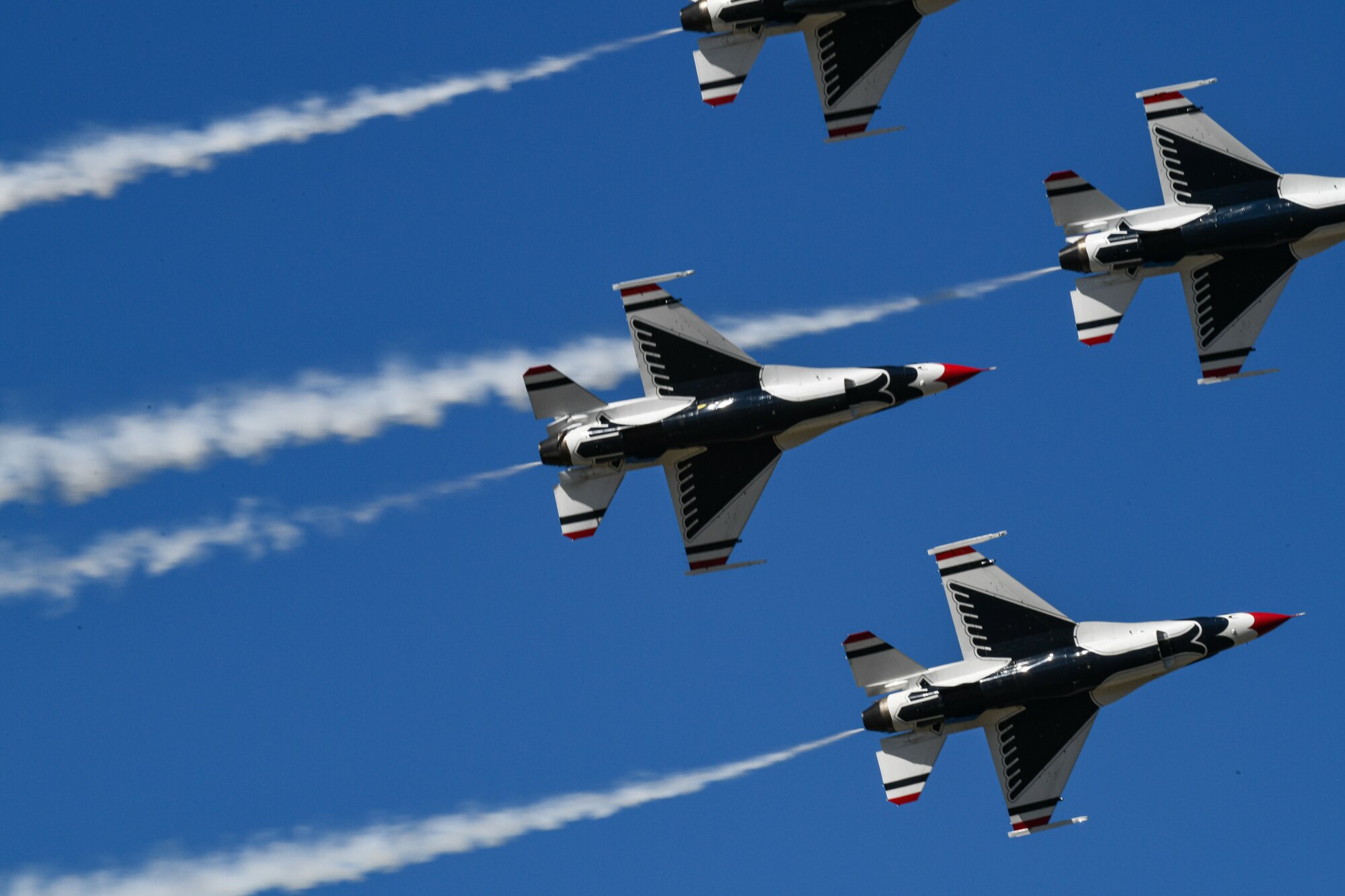 Four Thunderbirds F-16's in flight formation