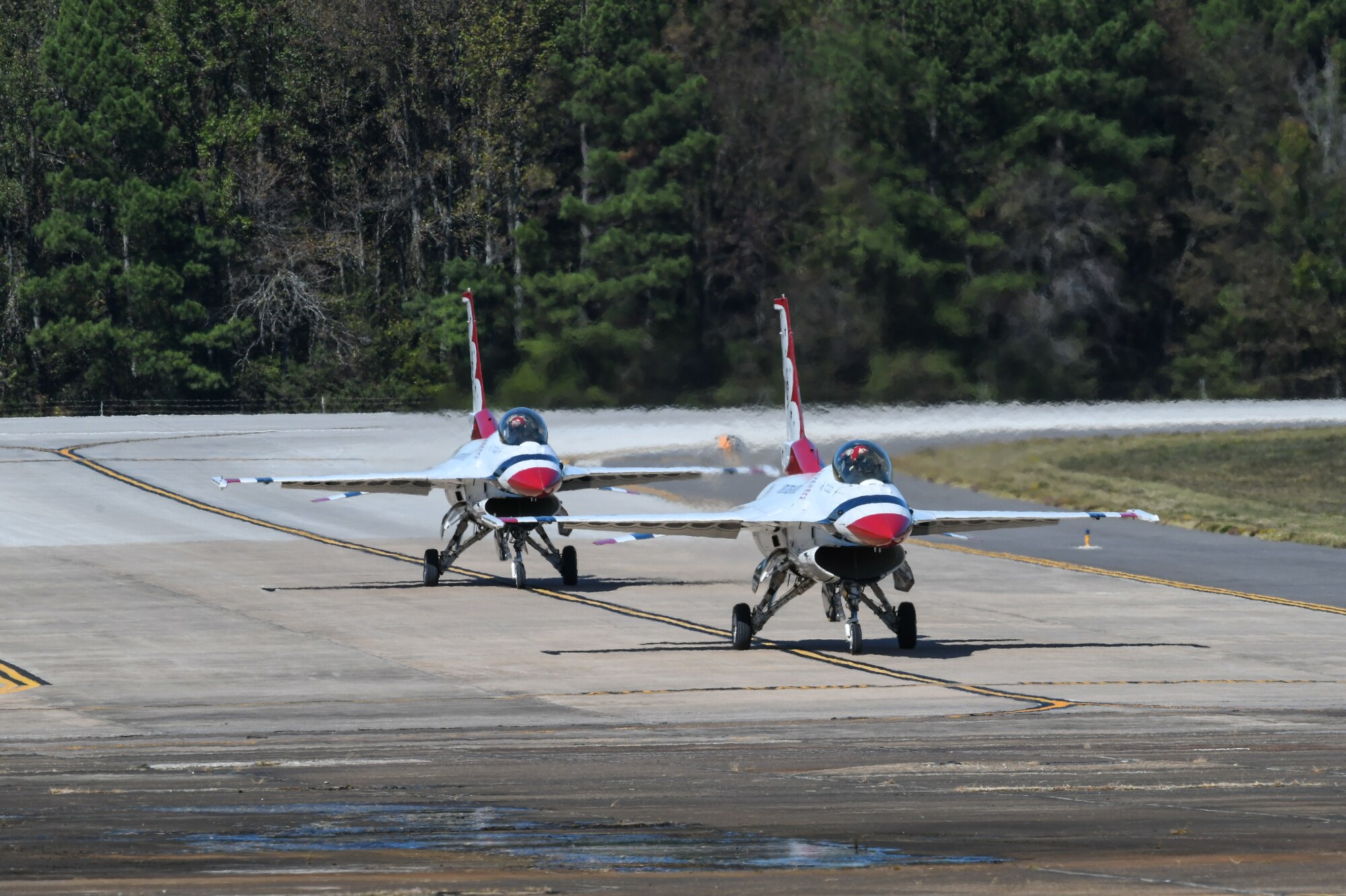 Tow F-16's on LRAFB airfield.