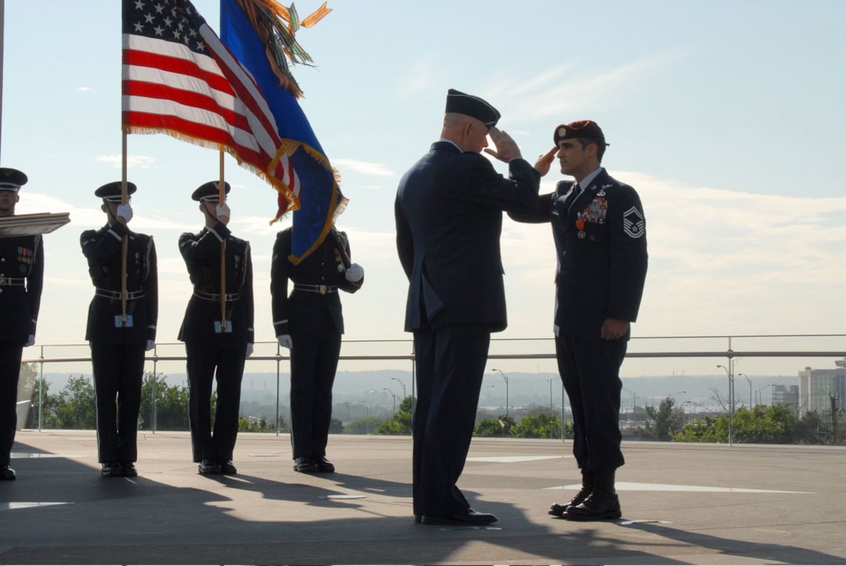 Air Force Chief of Staff Gen. T. Michael Moseley presents the Air Force Combat Action Medal to Senior Master Sgt. Ramón "CZ" Colón-López, who received the medal for heroic actions while deployed to Afghanistan in 2004, June 12, 2007, in Arlington, Va. The medal was presented for the first time to six Airmen at the ceremony held at the Air Force Memorial. (U.S. Air Force photo)