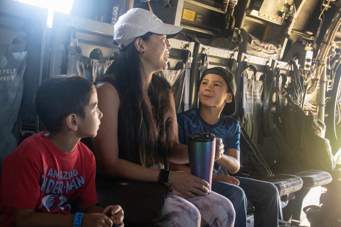 U.S. Marines with Marine Medium Tiltrotor Squadron (VMM) 268, Marine Aircraft Group 24, 1st Marine Aircraft Wing, interact with families at the fourth annual Waimea Fall Festival at Spencer K. Schutte Waimea District Park, Hawaii, Oct. 14, 2023. VMM-268 showcased a static display of an MV-22B and offered educational tours for event-goers. VMM-268's participation in the festival enhanced community relations and educated the public about their aircraft. (U.S. Marine Corps photo by Lance Cpl. Logan Beeney)