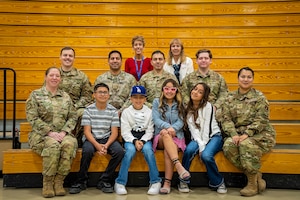 Military members, South Valley Academy students and staff, and a Blue Star Mothers representative pose for a group photo.