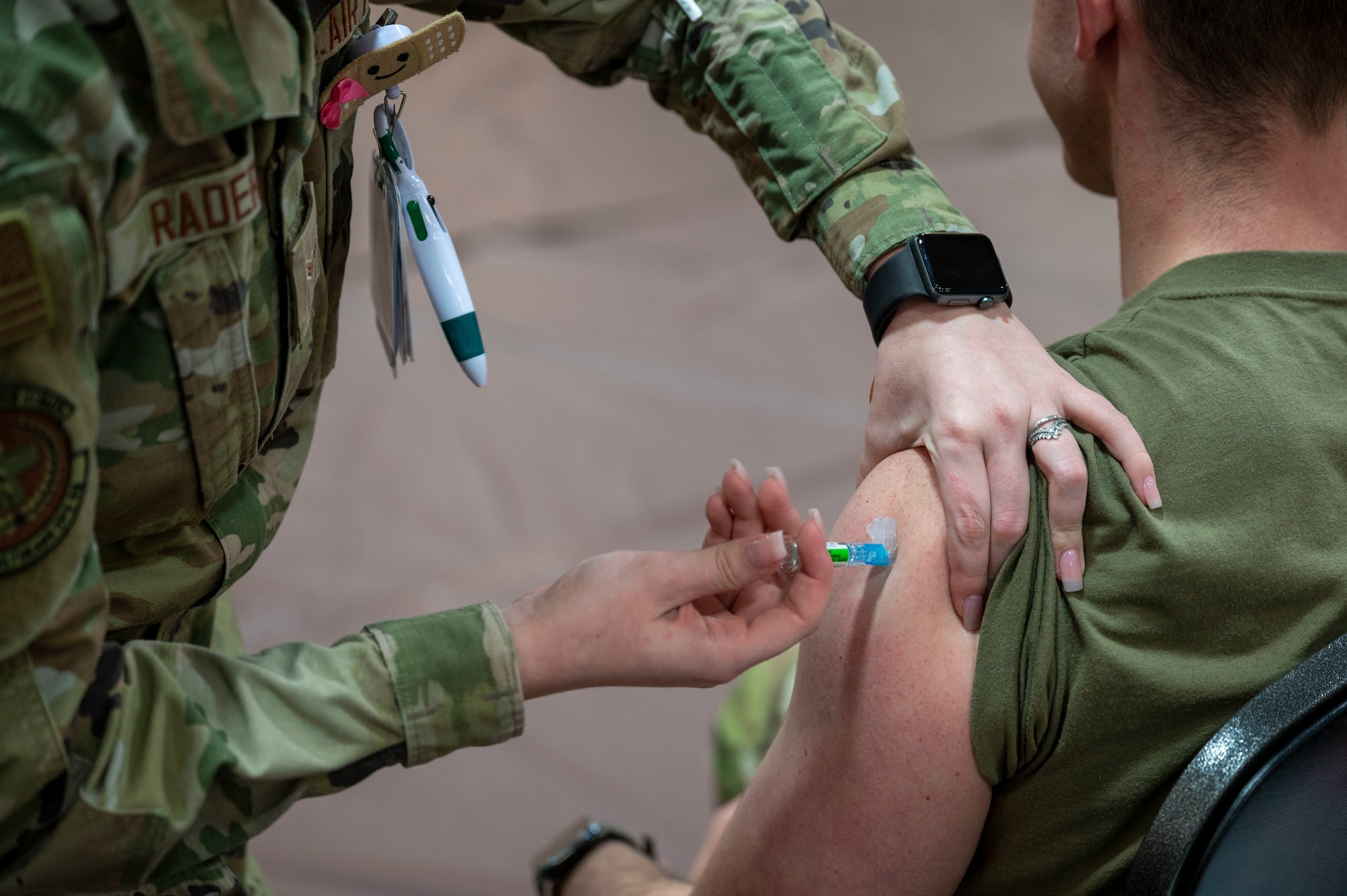 An Airman from the 22nd Medical Group gives the influenza vaccine to an Airman assigned to McConnell Air Force Base, Kansas, Oct. 19, 2023, at McConnell. The 22nd group held a three-day campaign to ensure all Active Duty, Guard, Reserve and civilian personnel received their annual flu shot. (U.S. Air Force photo by Airman 1st Class Gavin Hameed)