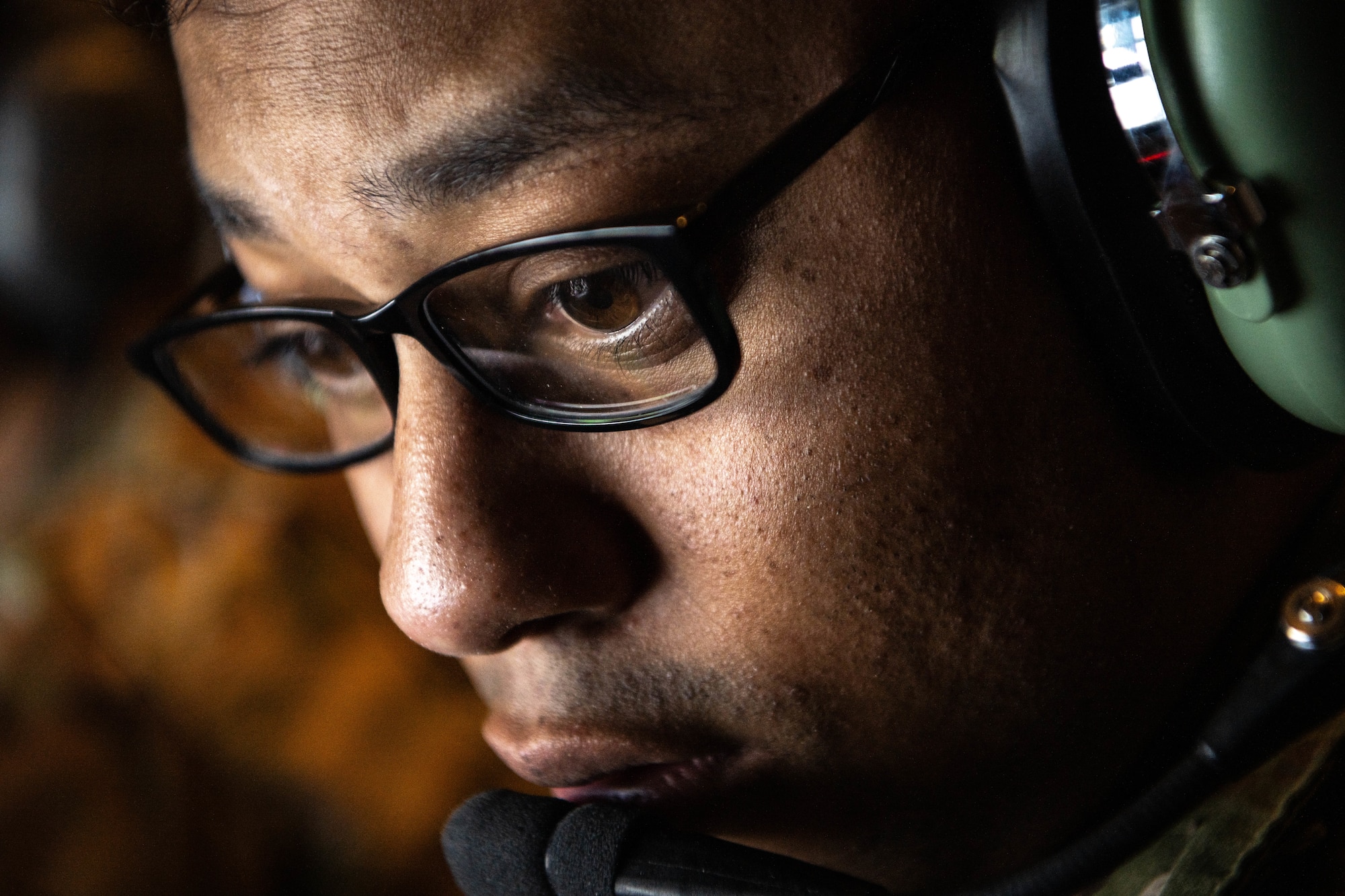 a very close image of a man wearing glasses and headphones
