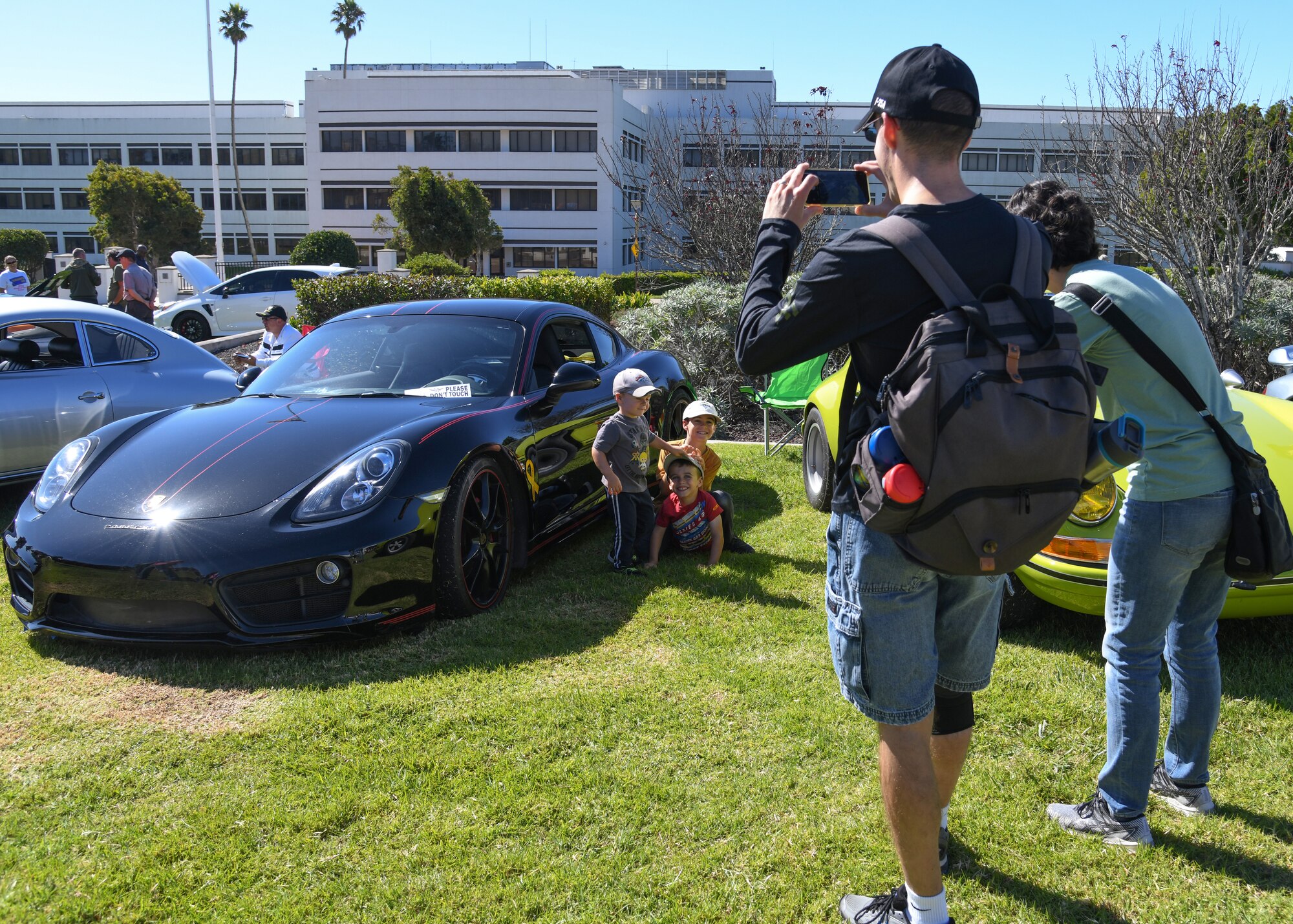 Attendees gather to take a photo in front of a vehicle at the Pacific Coast Club at Vandenberg Space Force Base, Calif. Oct. 16, 2023