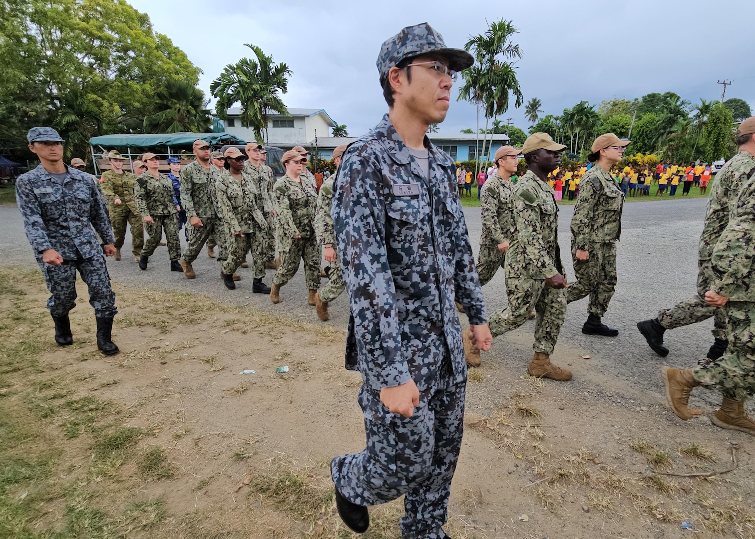 WEWAK, Papua New Guinea (Oct. 20, 2023) – U.S. Navy and Japan Maritime Self-Defense Force service members parade to Pacific Partnership 2023's Papua New Guinea closing ceremony, Oct. 20. Now in its 18th year, Pacific Partnership is the largest annual multinational humanitarian assistance and disaster relief preparedness mission conducted in the Indo-Pacific. (U.S. Navy photo by Chief Mass Communication Specialist Kegan E. Kay)