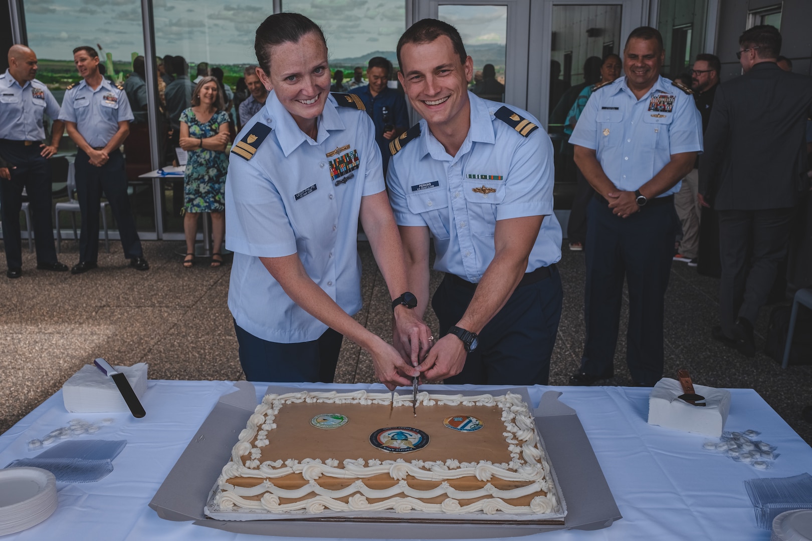 Coast Guard members cut cake for ribbon cutting ceremony. Coast Guard stands up new marine environmental response unit in Honolulu.