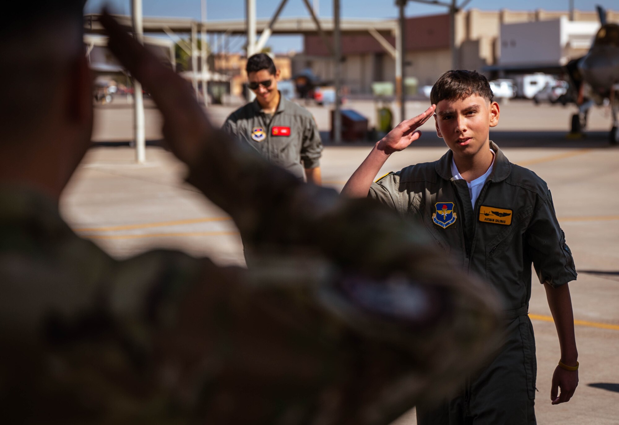 Isaac “Axe-man” Salinas, Luke Air Force Base pilot for a day, and his family receive a tour of Luke AFB