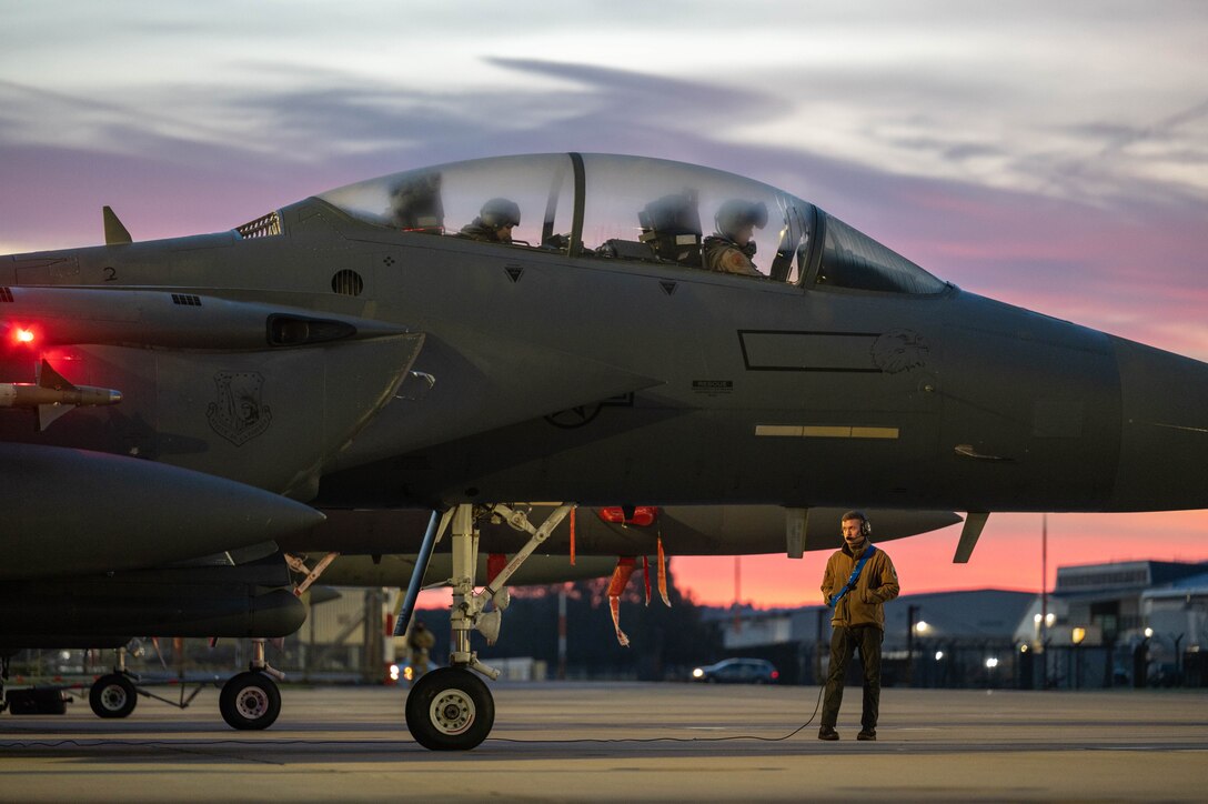 A U.S. Air Force crew chief assigned to the 494th Fighter Generation Squadron performs preflight checks on an F-15E Strike Eagle