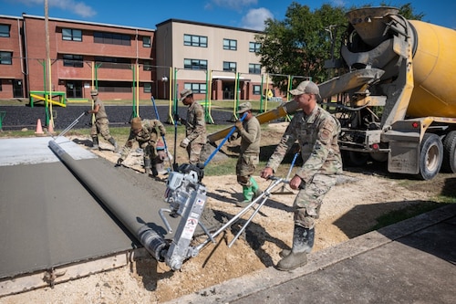 Airmen press and smooth concrete.