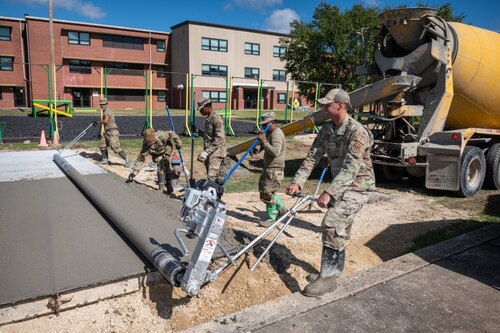 Airmen press and smooth concrete.