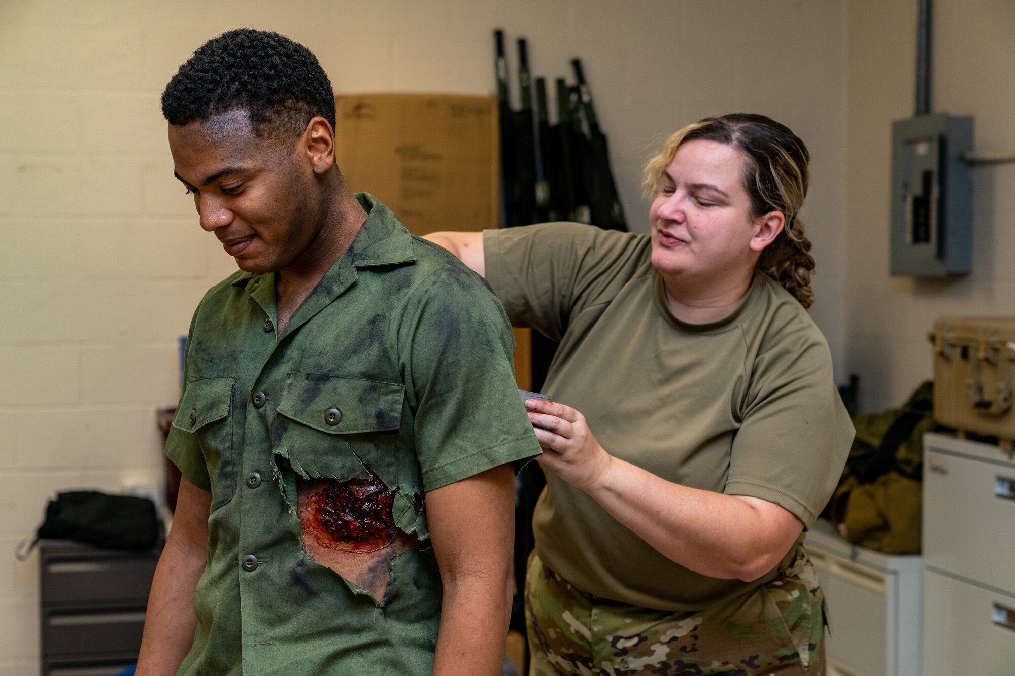 U.S. Air Force Master Sgt. Heather Bishop, 81st Dental Squadron dental lab flight chief, places fake blood and wounds onto Airman Phillip Brenner, 338th Training Squadron network systems operator student, during a training exercise at Keesler Air Force Base, Mississippi, Oct. 19, 2023.
