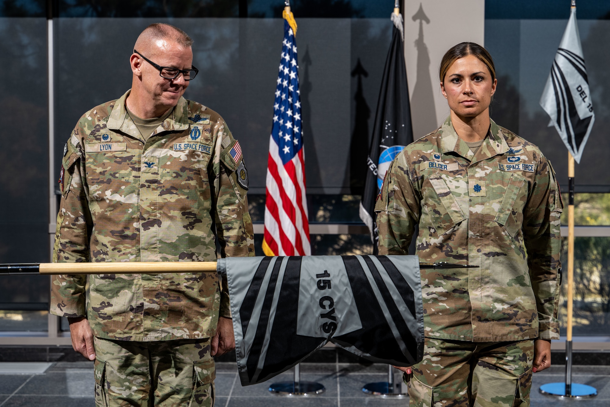 Two military members stand at attention