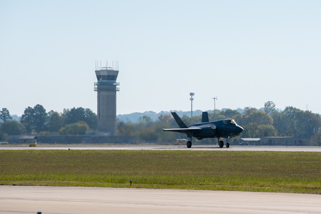 F-35A taxing down runway at Fort Smith airport. Control tower is in the background.