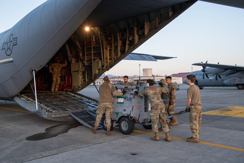 Airmen load cargo onto an aircraft