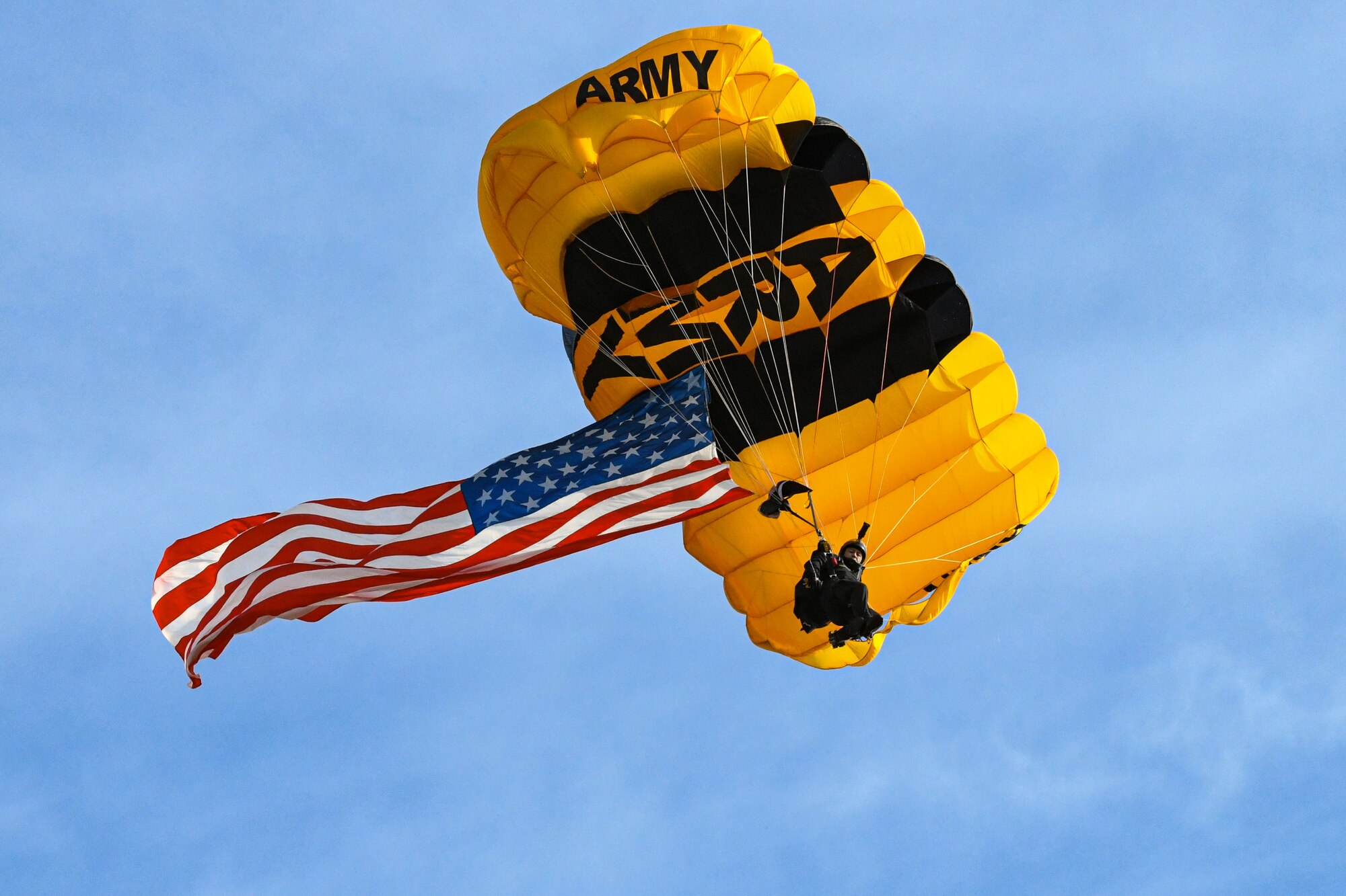 Paratrooper flying with the US flag.