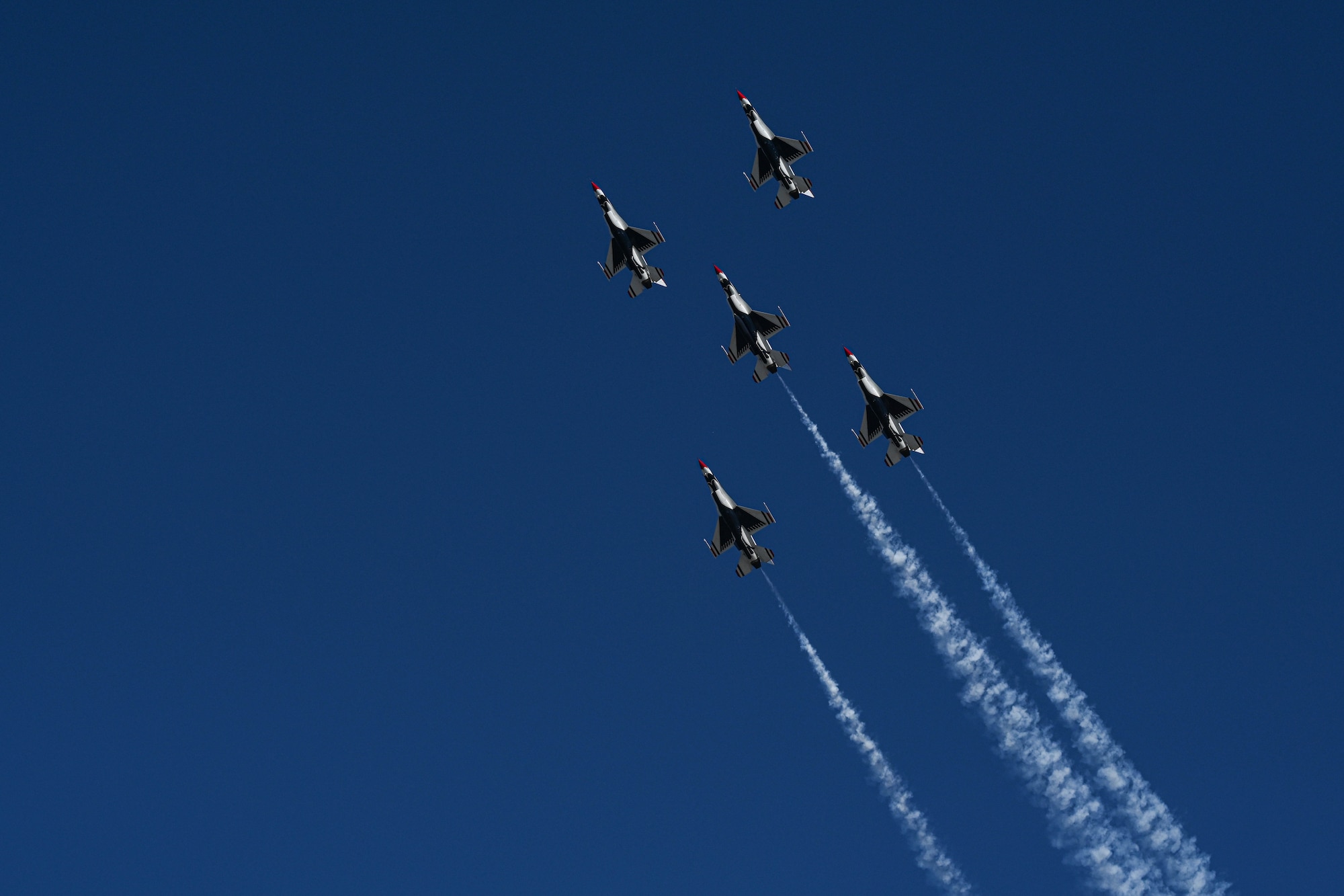 Five Thunderbirds flying in air.